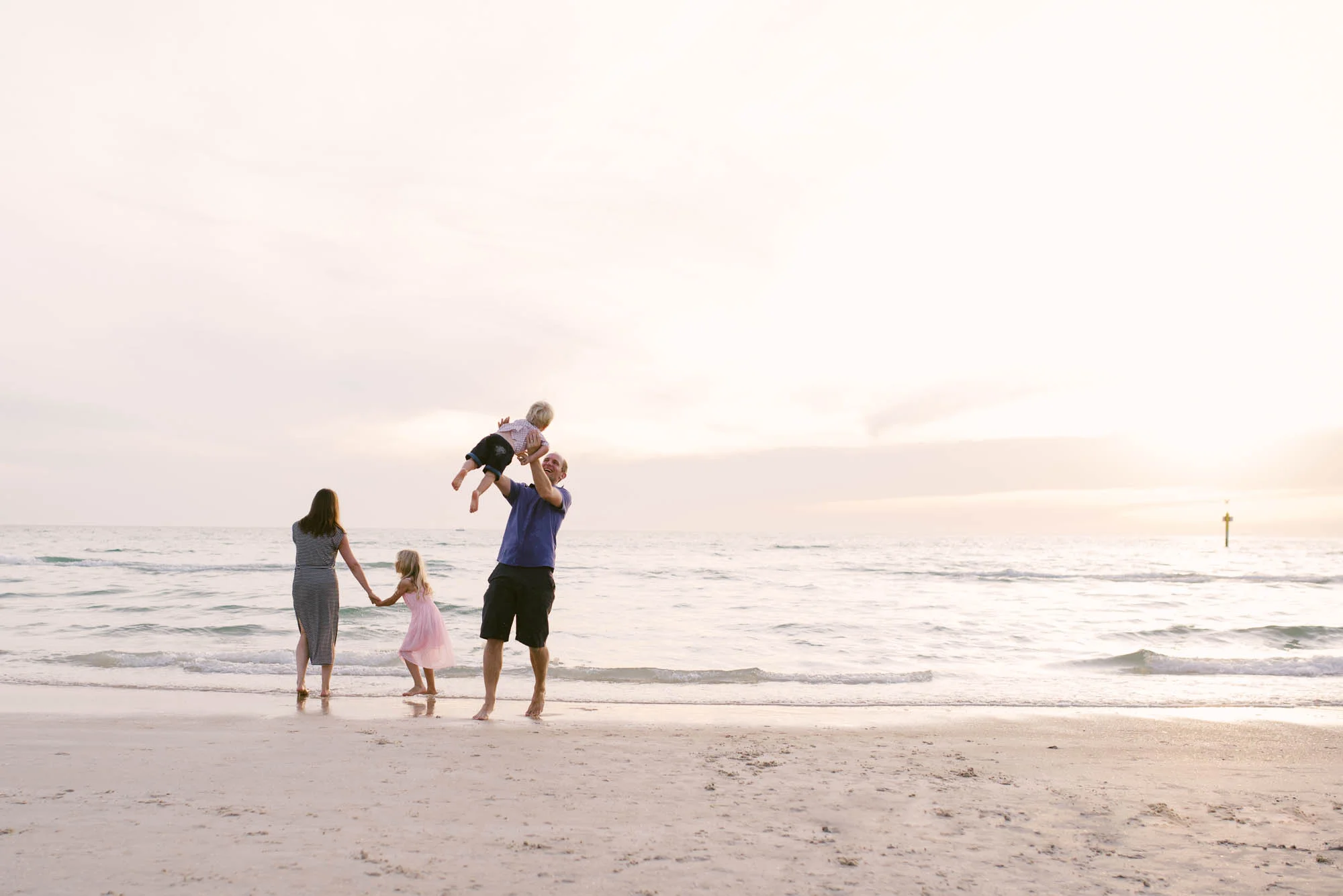 melbourne_family_photographer_family_playing_together_at_the_beach_at_sunset.jpg