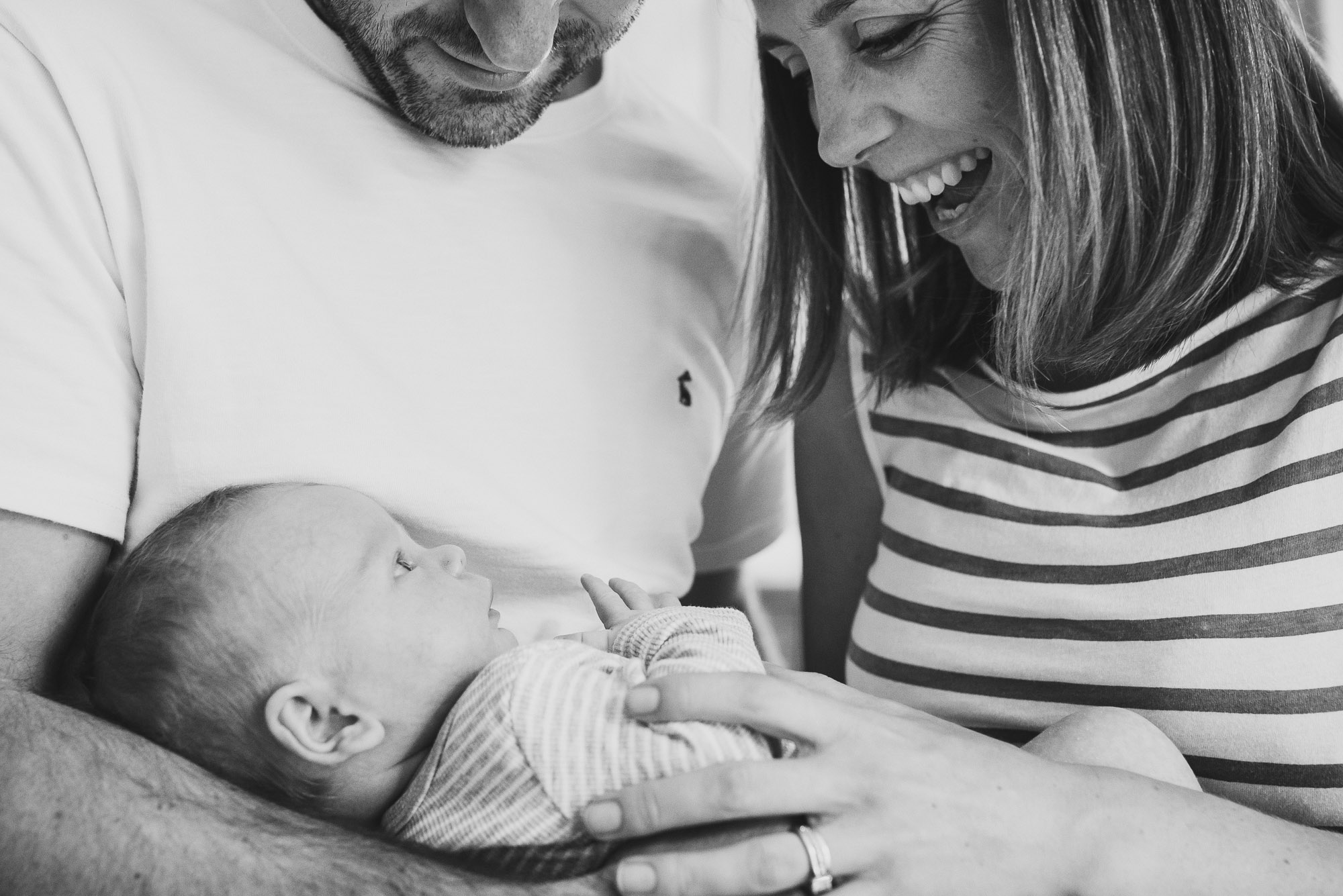 mum-and-dad-holding-and-smiling-at-newborn-black-and-white-jenny-rusby-photography-melbourne-newborn-photographer.jpg