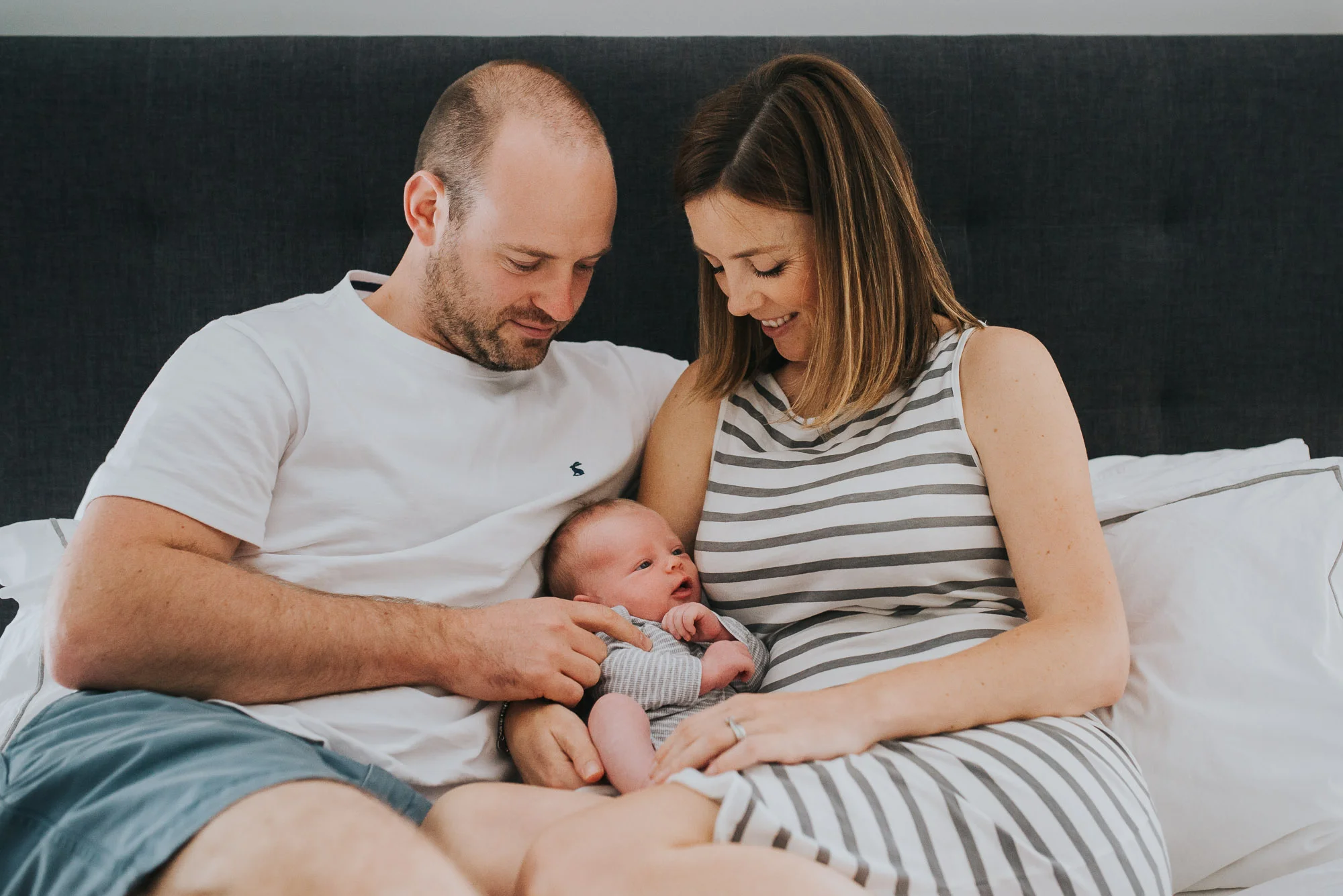 mum-dad-and-newborn-on-the-bed-newborn-photography-melbourne-jenny-rusby-photography.jpg