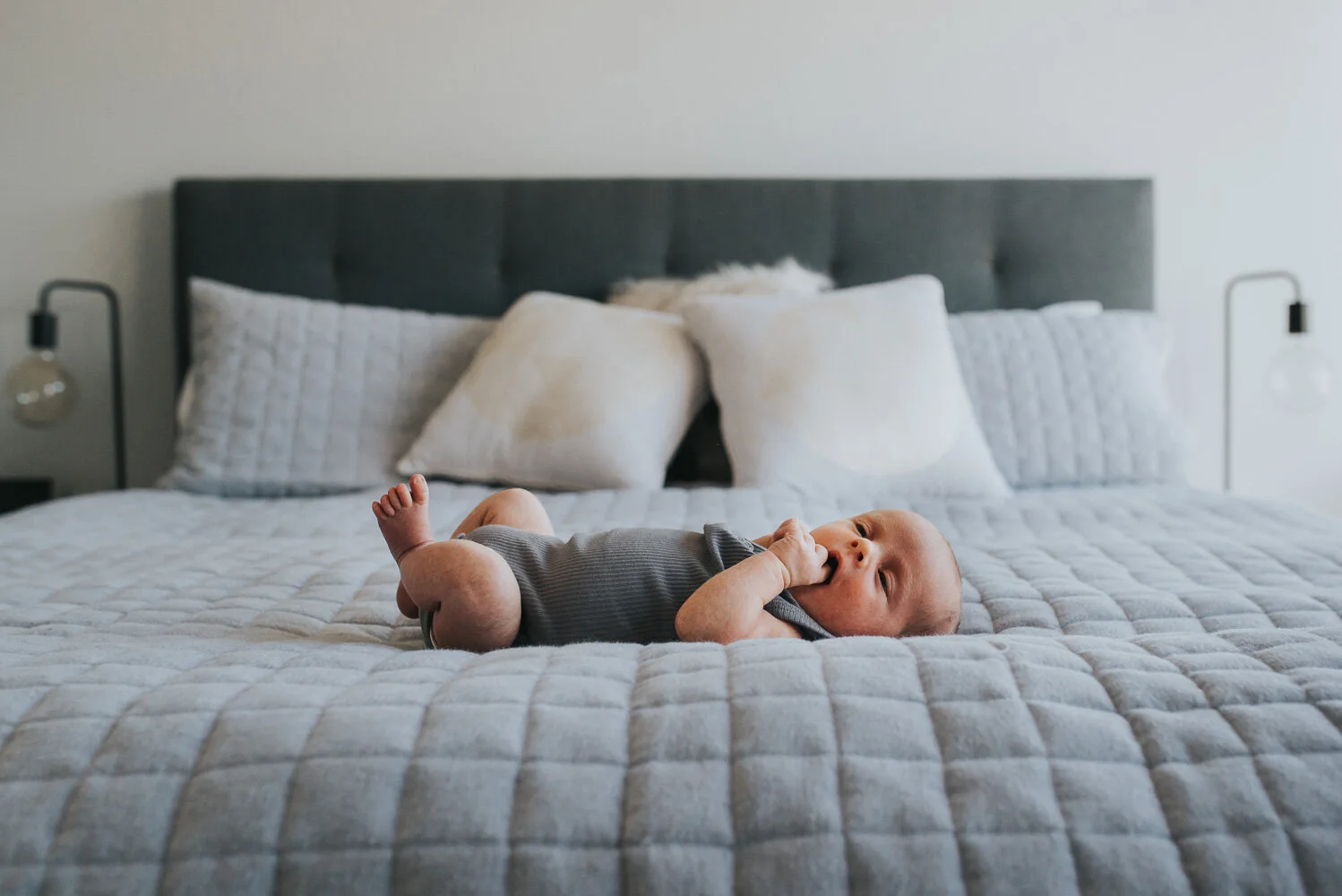 newborrn_laying_on_master_bed_at_home_melbourne_mornington_peninsula_lifestyle_photographer.jpg