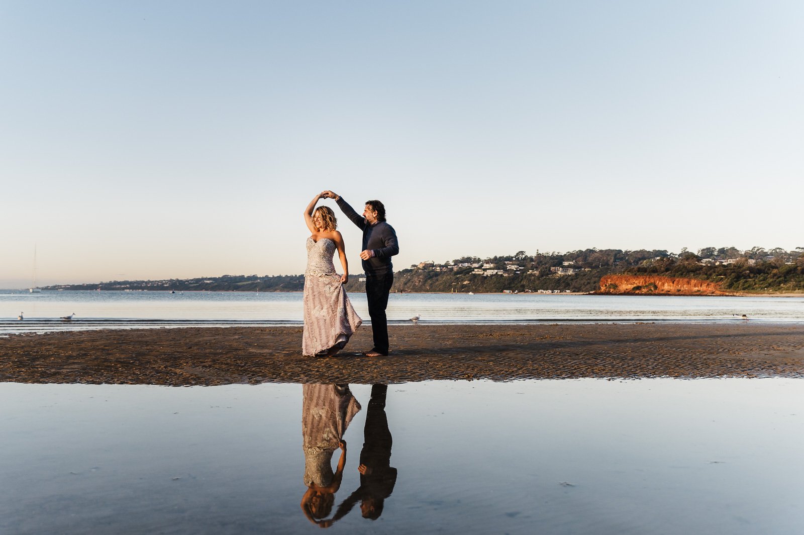 couple_dancing_together_at_beach_sunset_mornington_peninsula_family_photographer_water_reflection-1.jpg