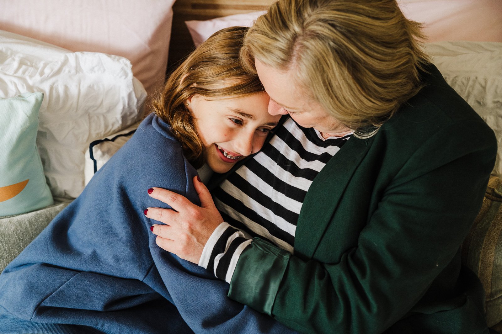mother_and_daughter_cuddling_together_on_bed_at_home_family_photographer_melbouurrne-1.jpg