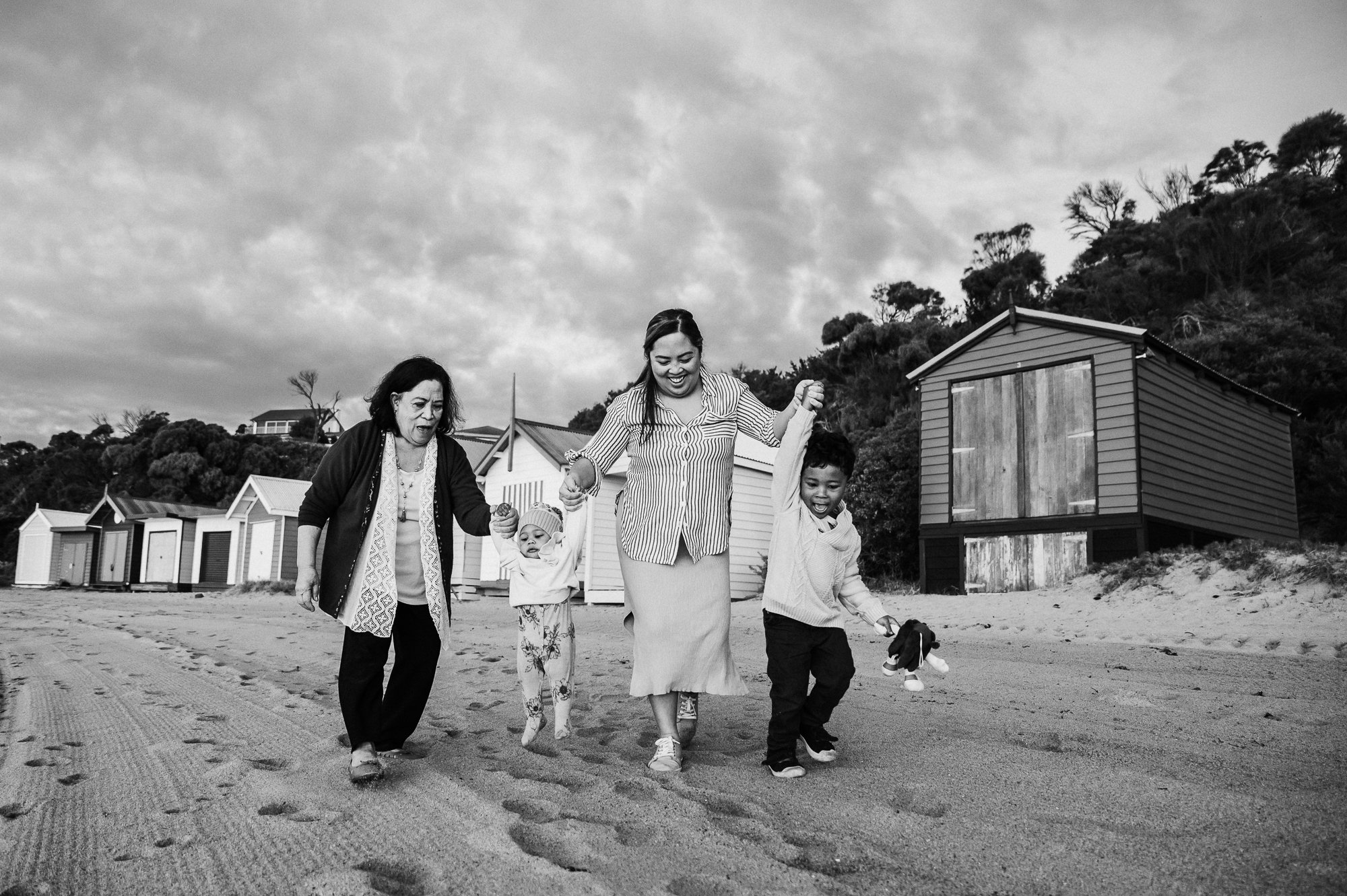 family_holding_hands_walking_smiling_laughing_beach_sunset_melbourne_family_photographer_jenny_rusby-1.jpg