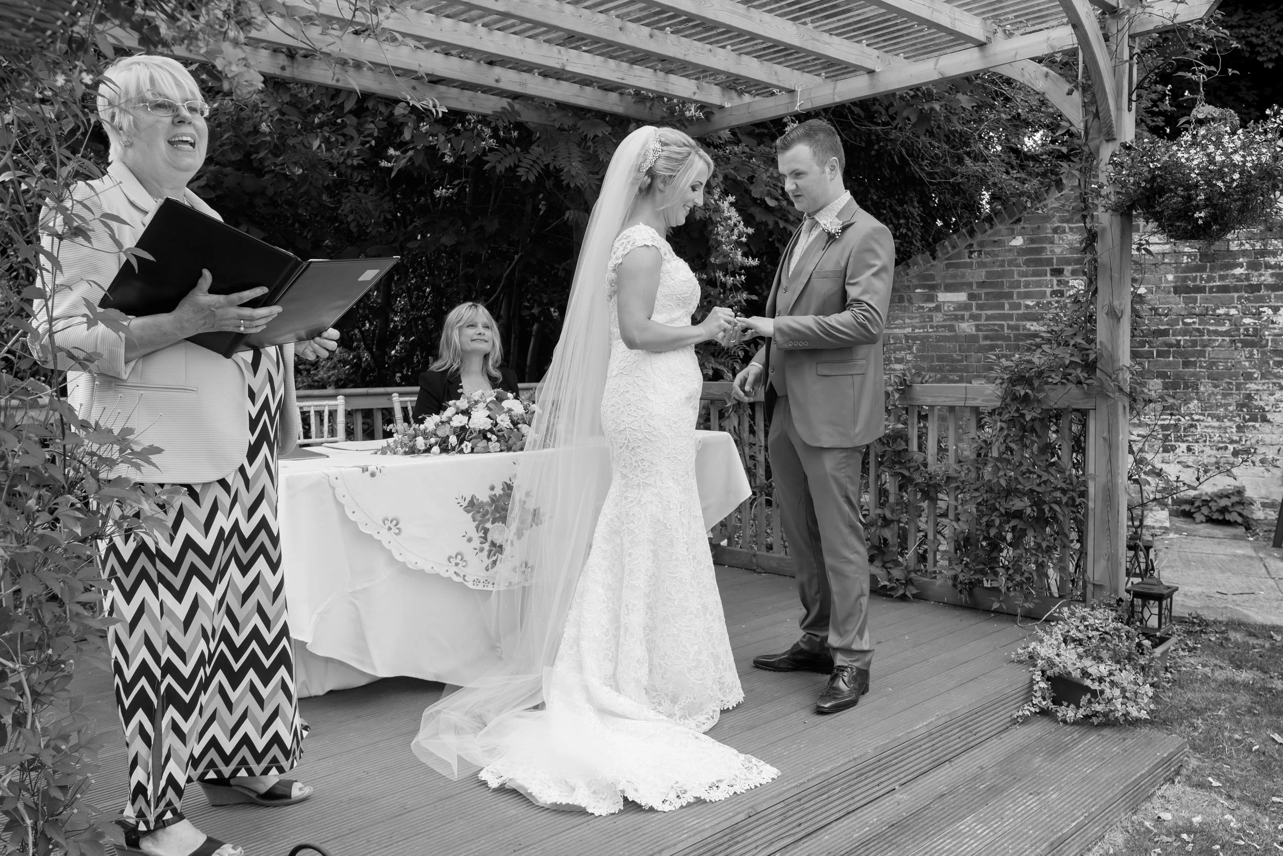 Outdoor wedding ceremony - exchanging the rings - Hertfordshire wedding venue