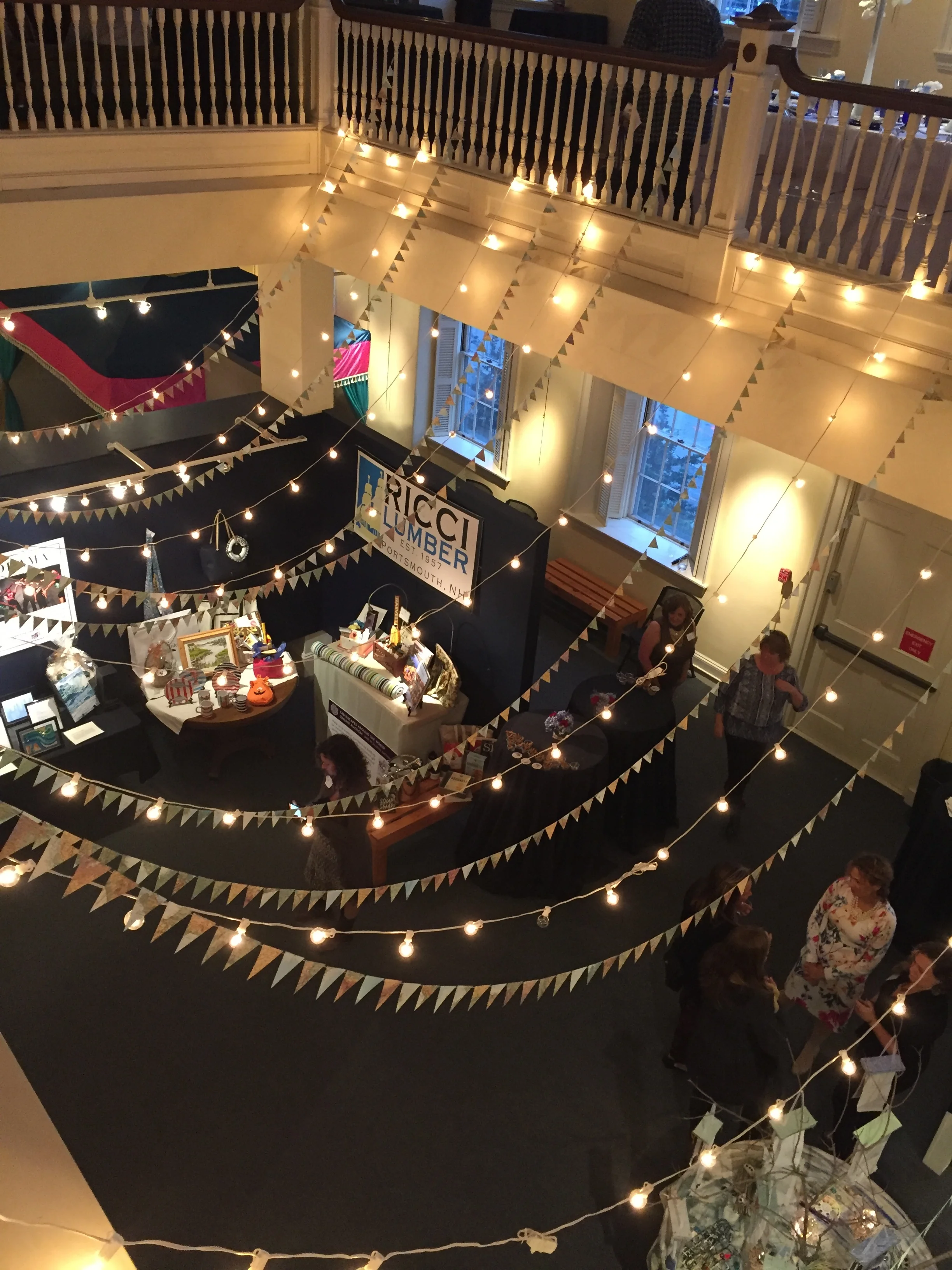 Cafe lights 12" apart installed with vintage map garlands at Discover Portsmouth , Portsmouth NH.