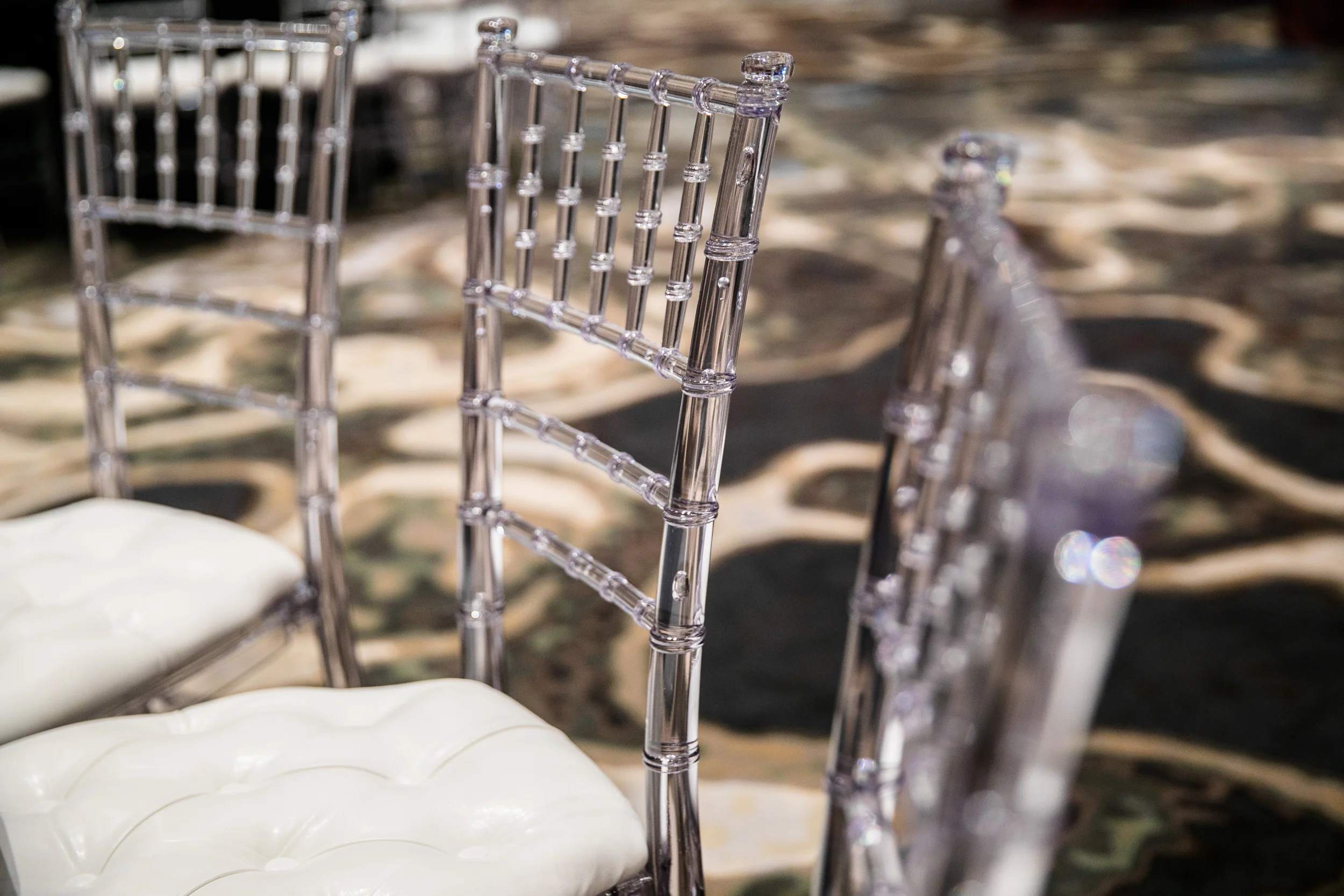 Acrylic clear chiavari chairs. White leather tufted cushions included.