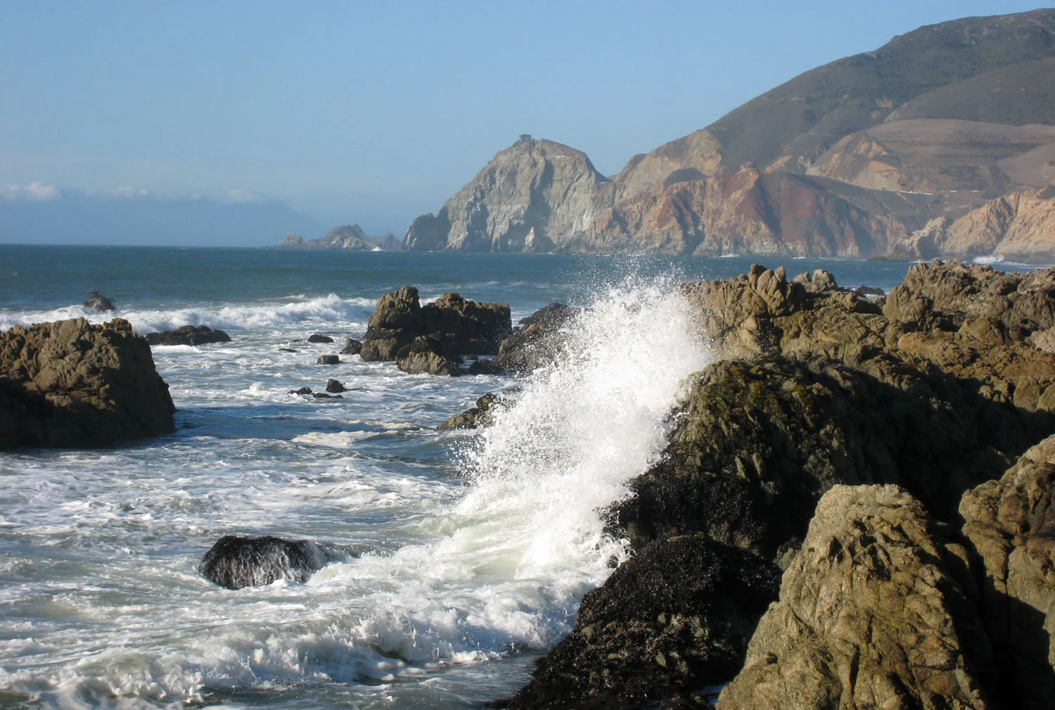 Montara coast rocky shoreline, Devil's Slide Promontory in distance