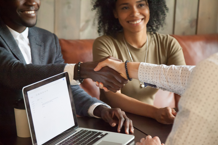 Happy-african-american-couple-making-deal-handshaking-caucasian-broker,-closeup-914989724_727x484.jpeg