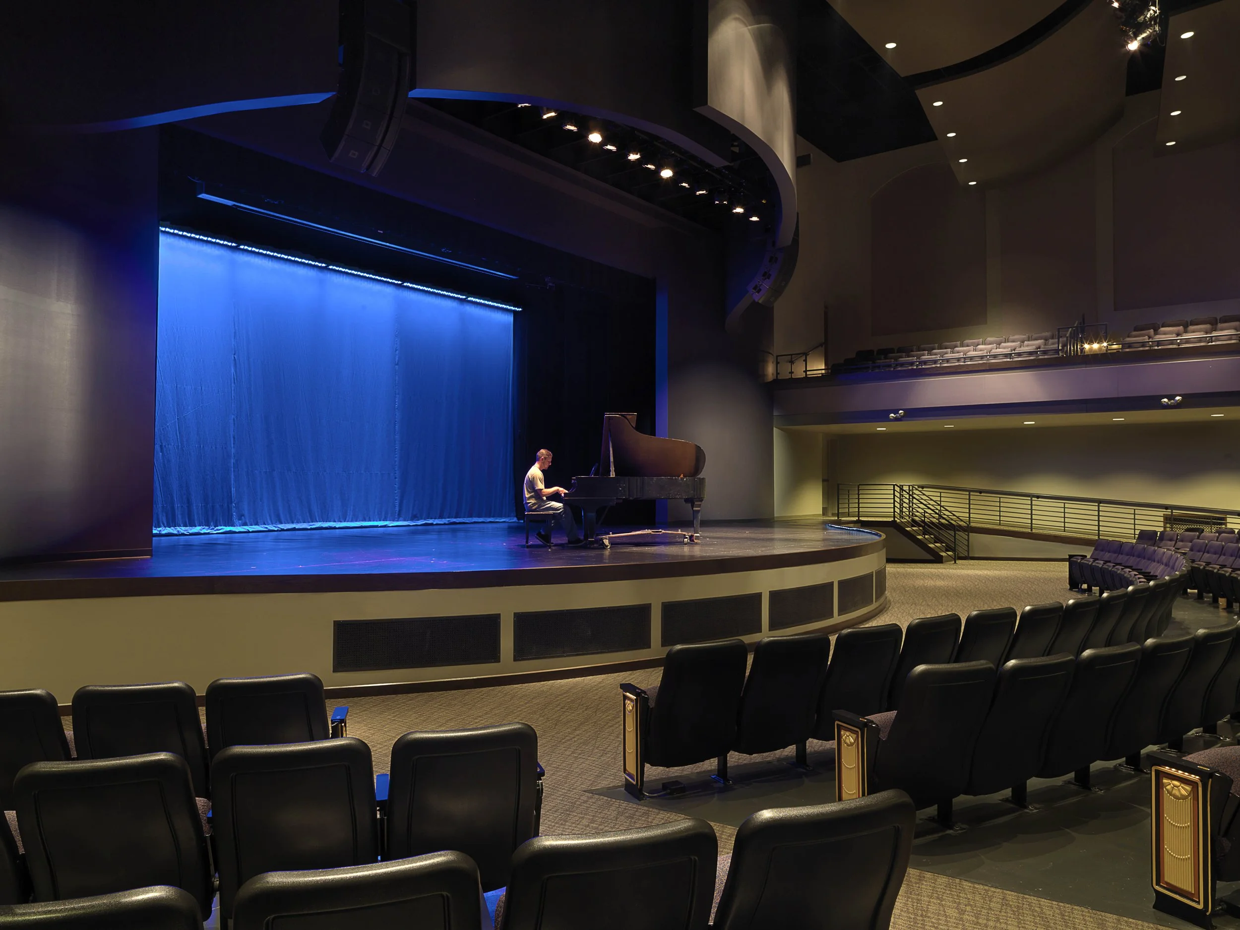Man on stage playing piano.