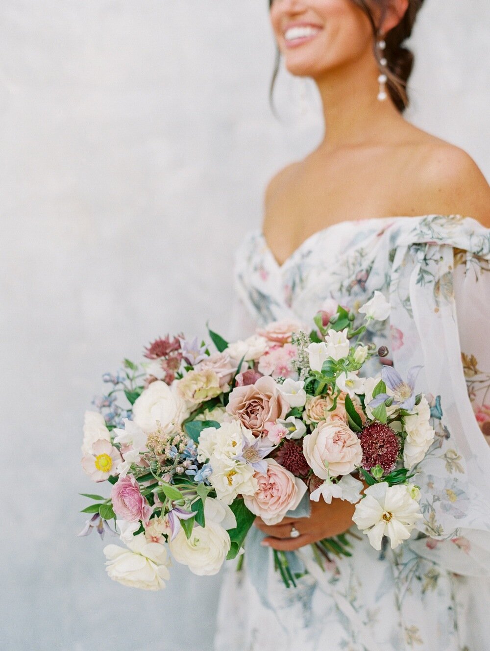 Bride-in-Monique-Lhuillier-floral-Jardin-gown-at-her-Sunstone-Villa-Wedding-with-a-pastel-garden-style-bridal-bouquet.jpg