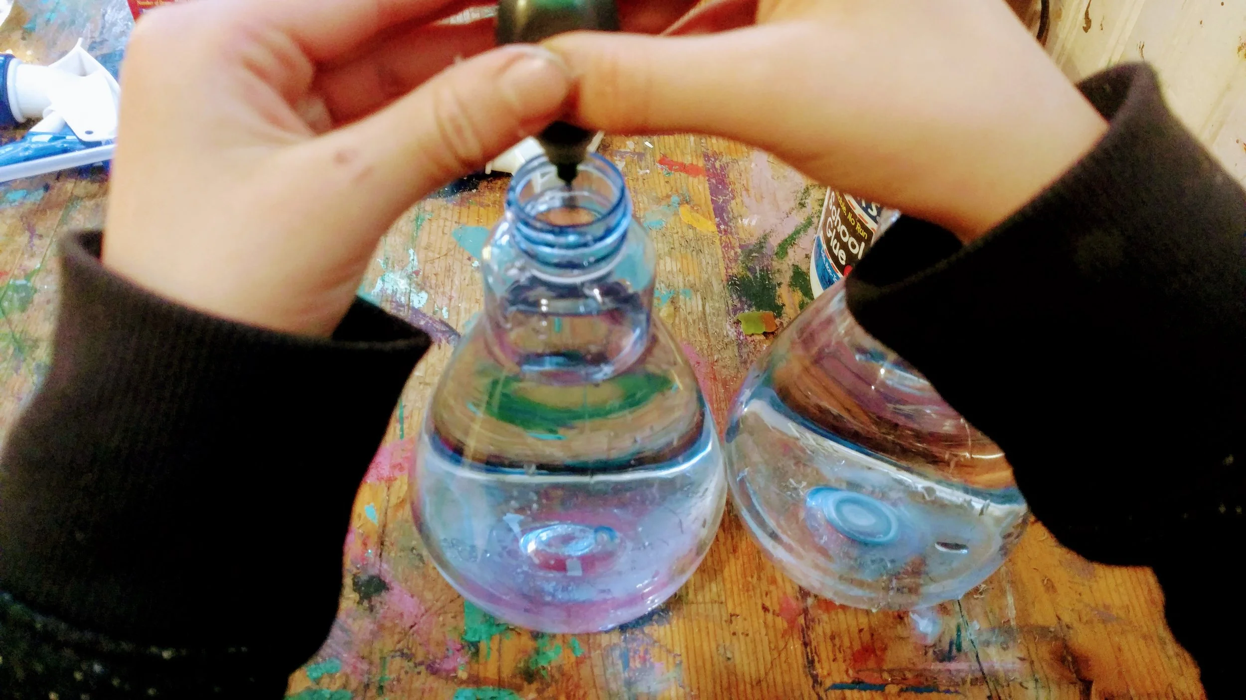 Add food coloring to spray bottles of water to paint the snow.