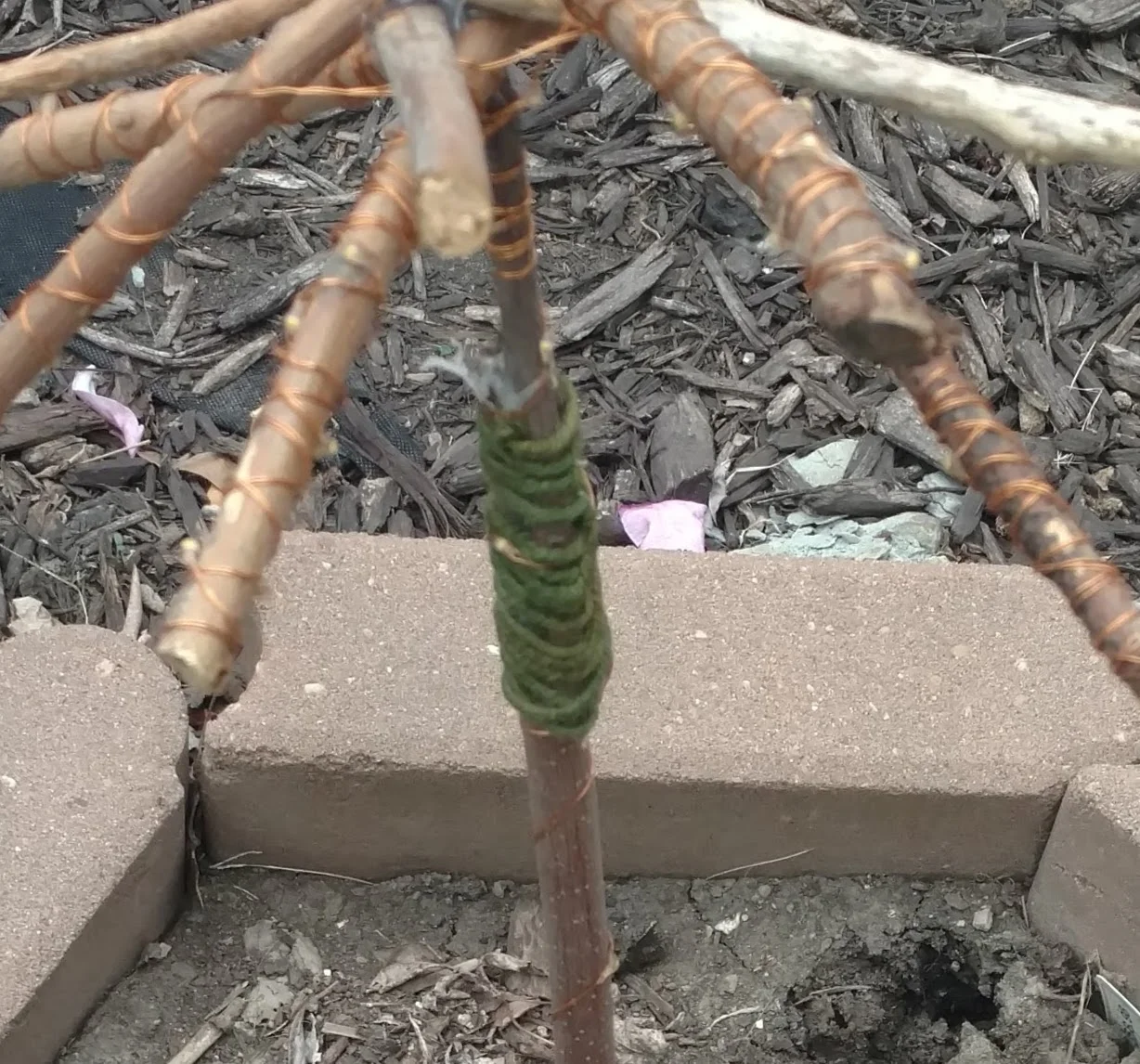 Stick and hot glue gun garden art sculpture.