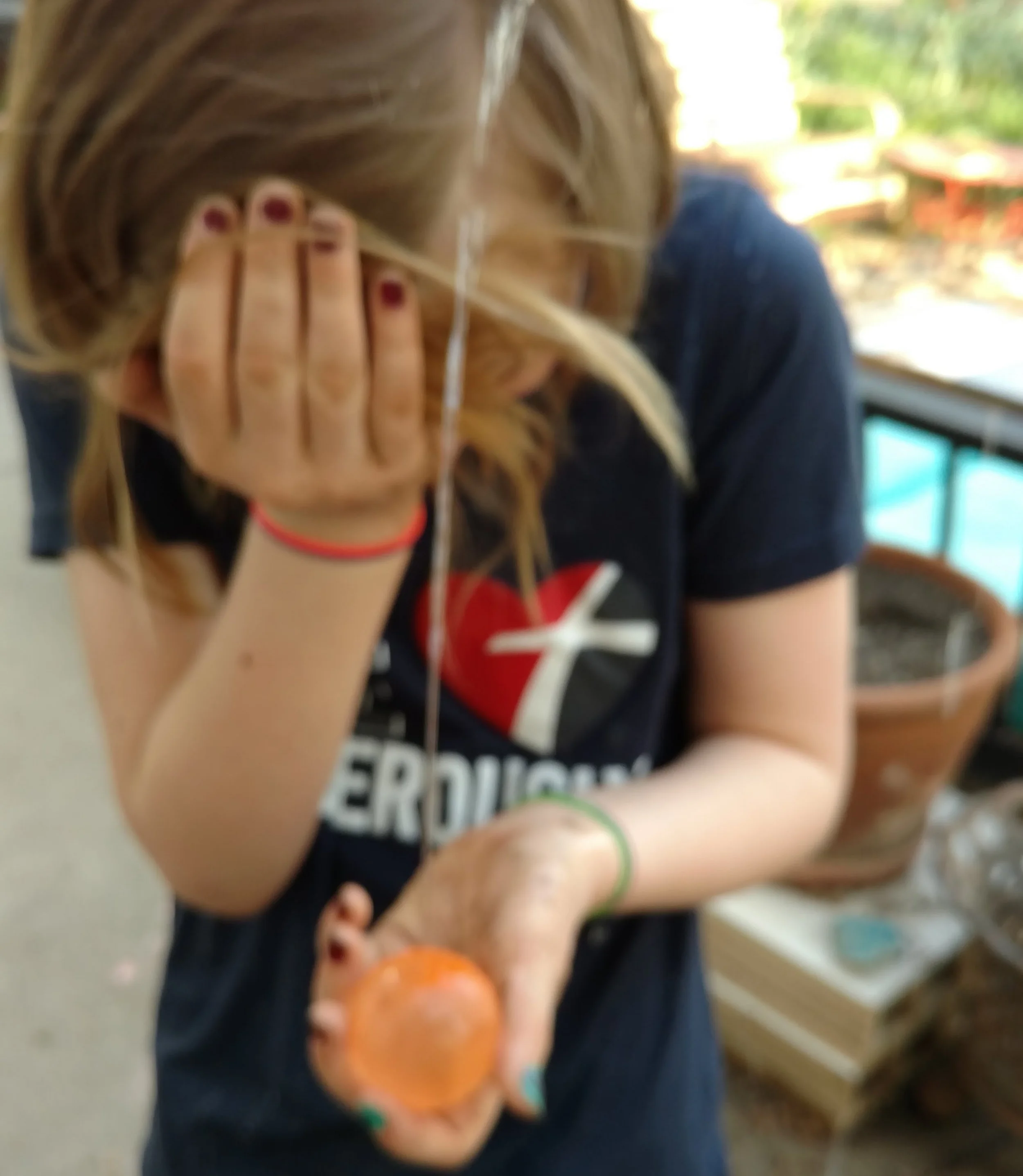 An eyeful of water after piercing the water balloon with a pin.