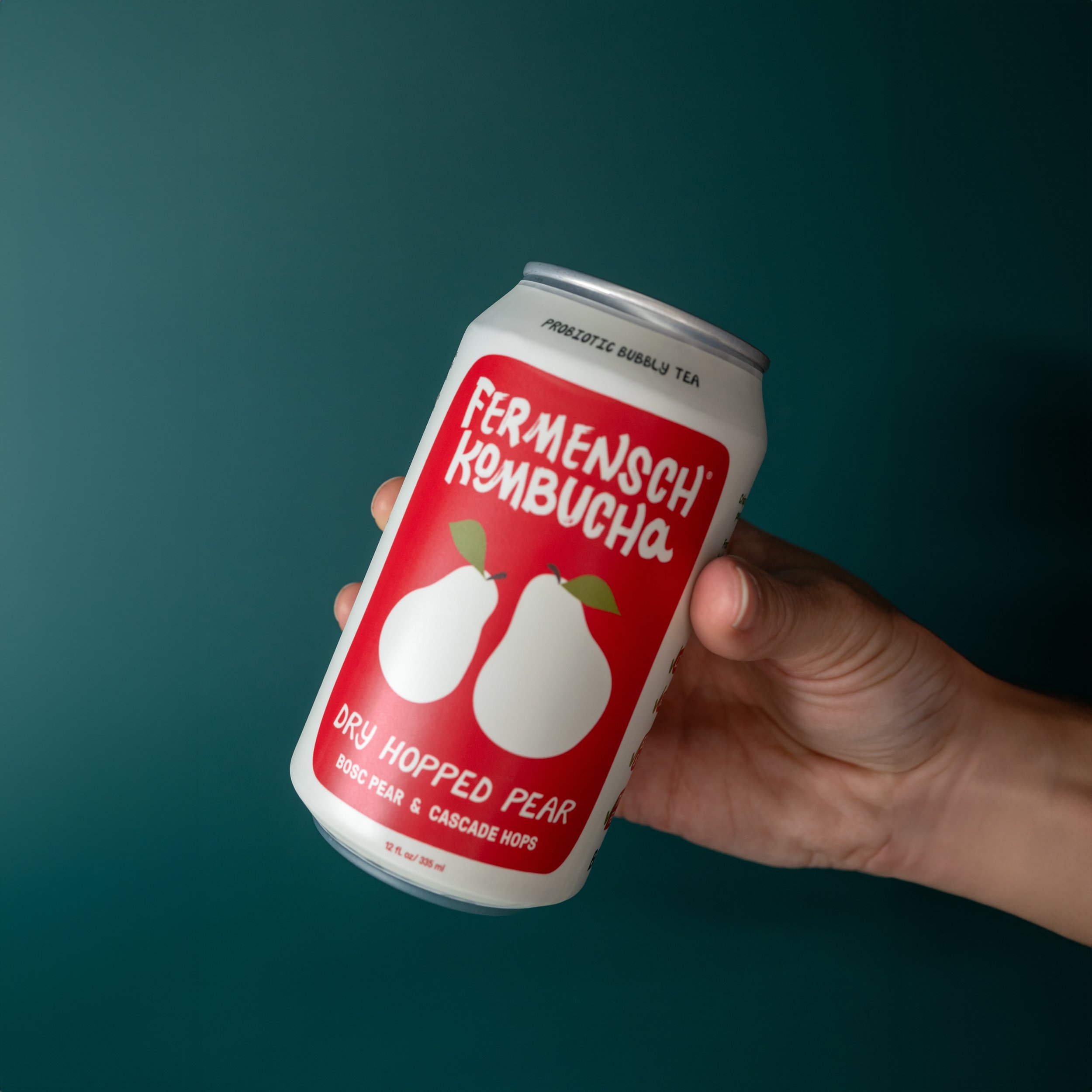 Dry Hopped Pear held on Teal background-Fermensch Kombucha_.jpg