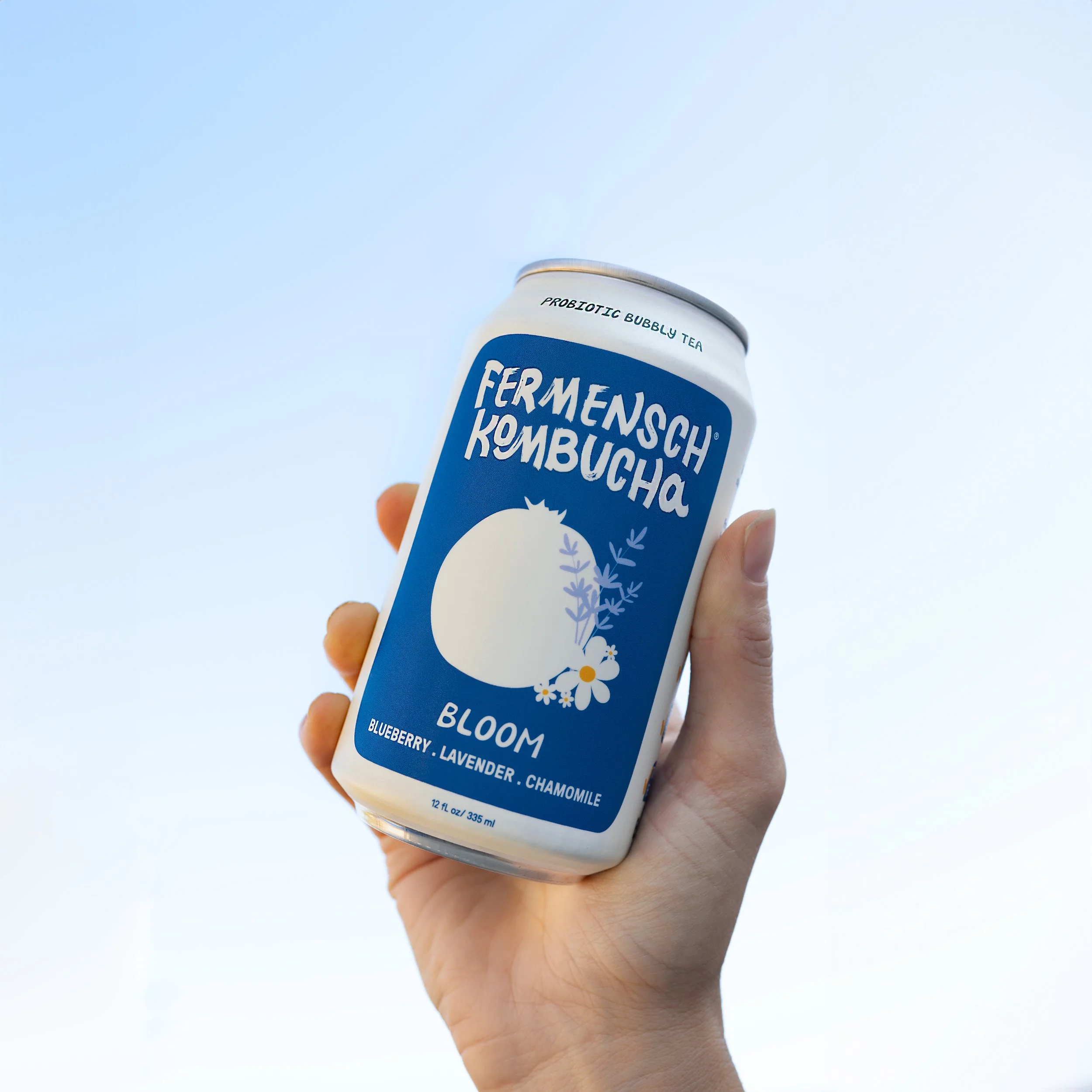 Bloom Can Held in Sky-Fermensch Kombucha.jpg