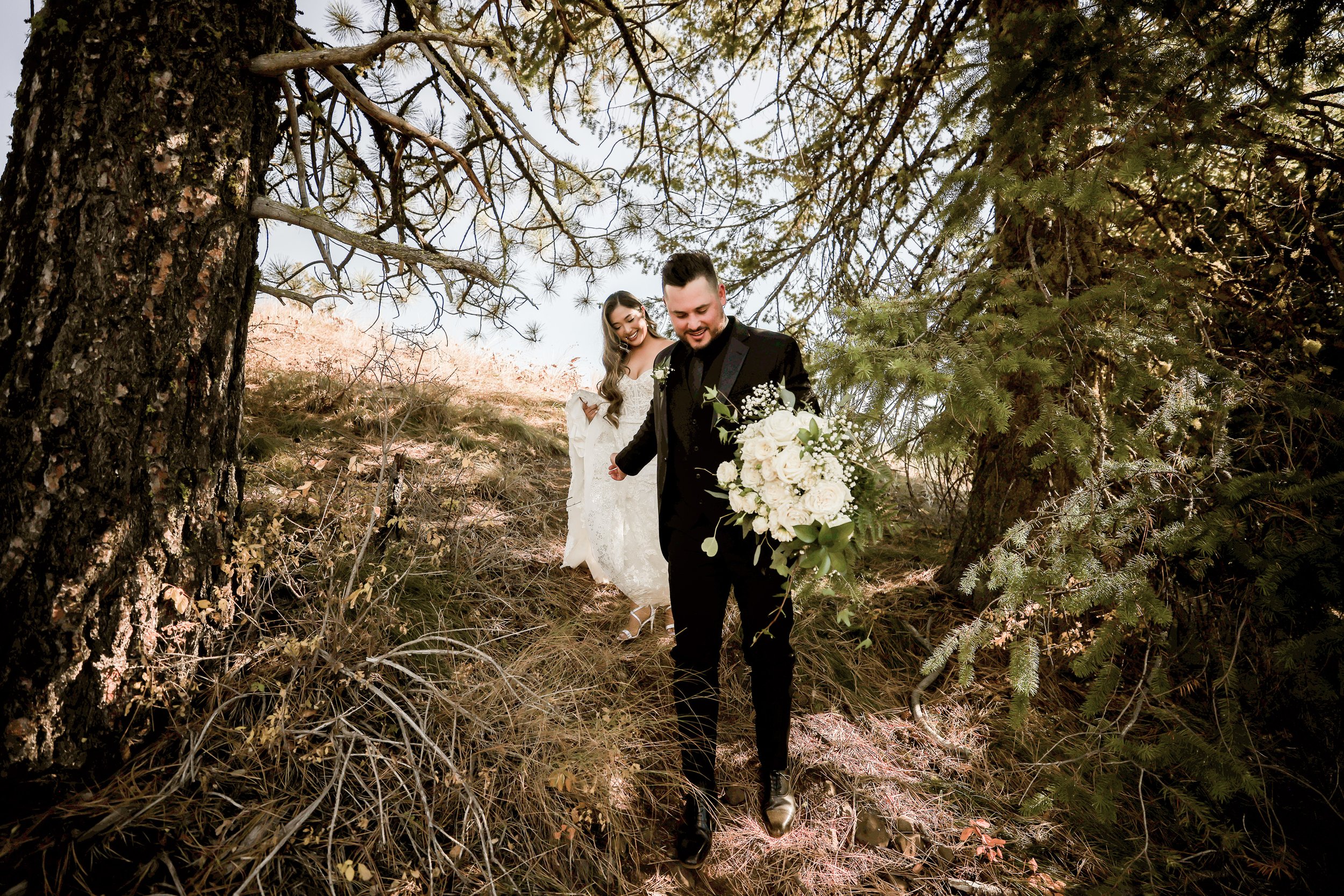 Smiling Groom Carries Bride's Flowers