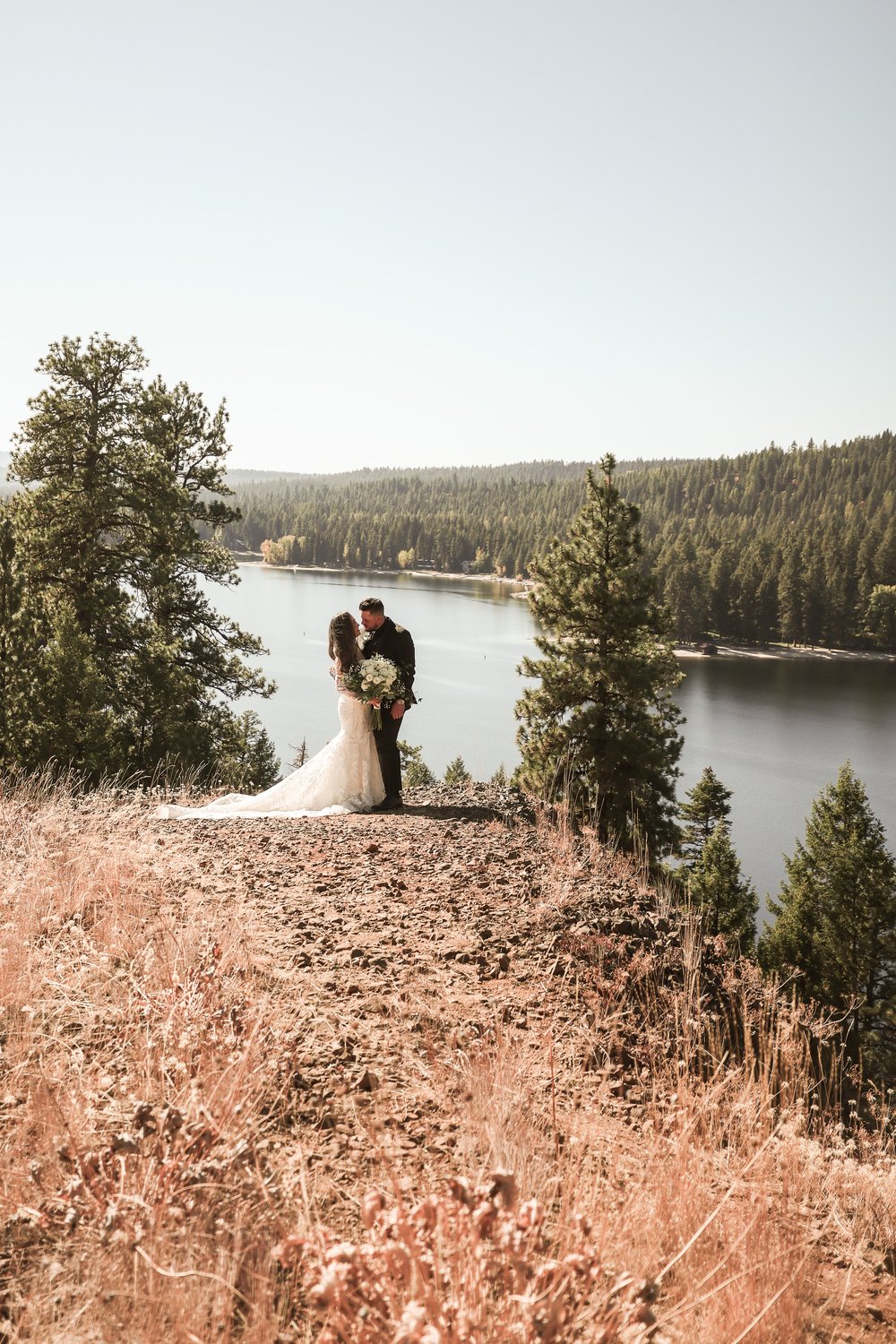 Bride and Groom on Ridge over Lake