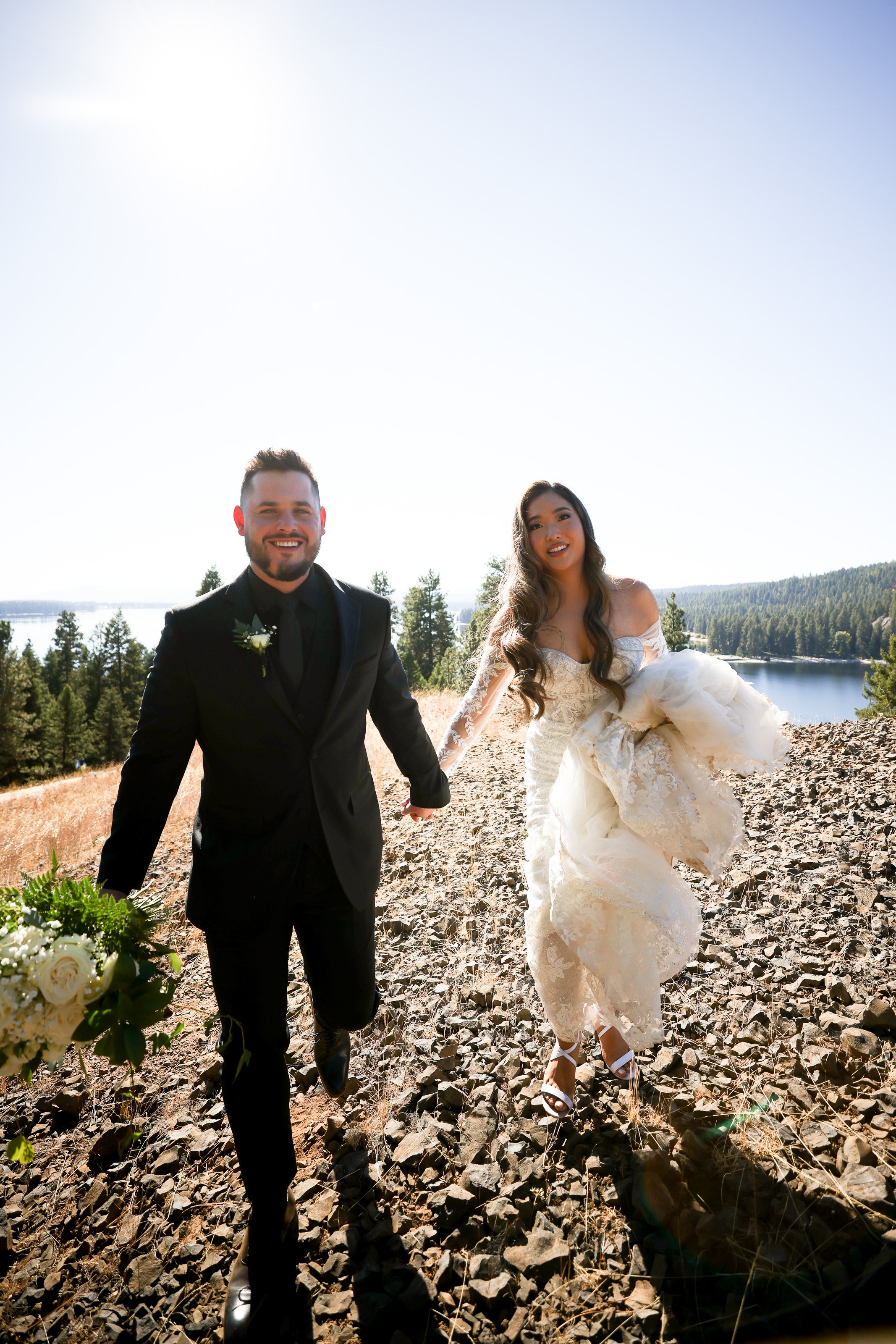 Wedding couple in Mountains hold hand