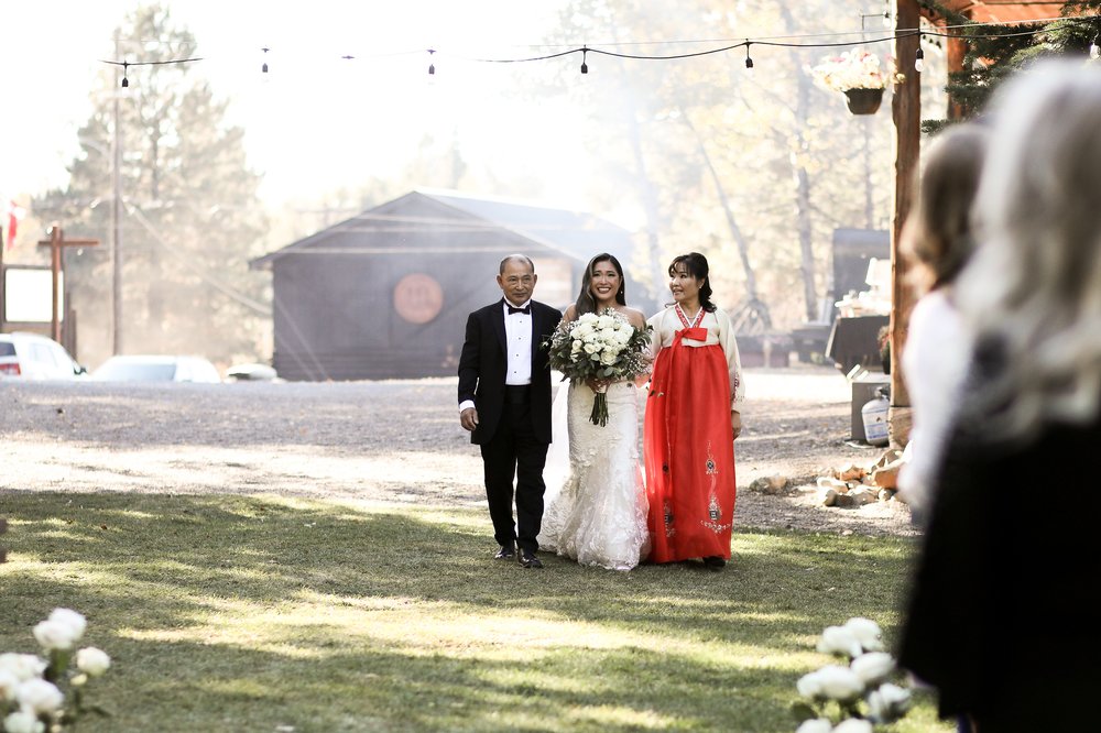 Bride walks with parents - Korean American