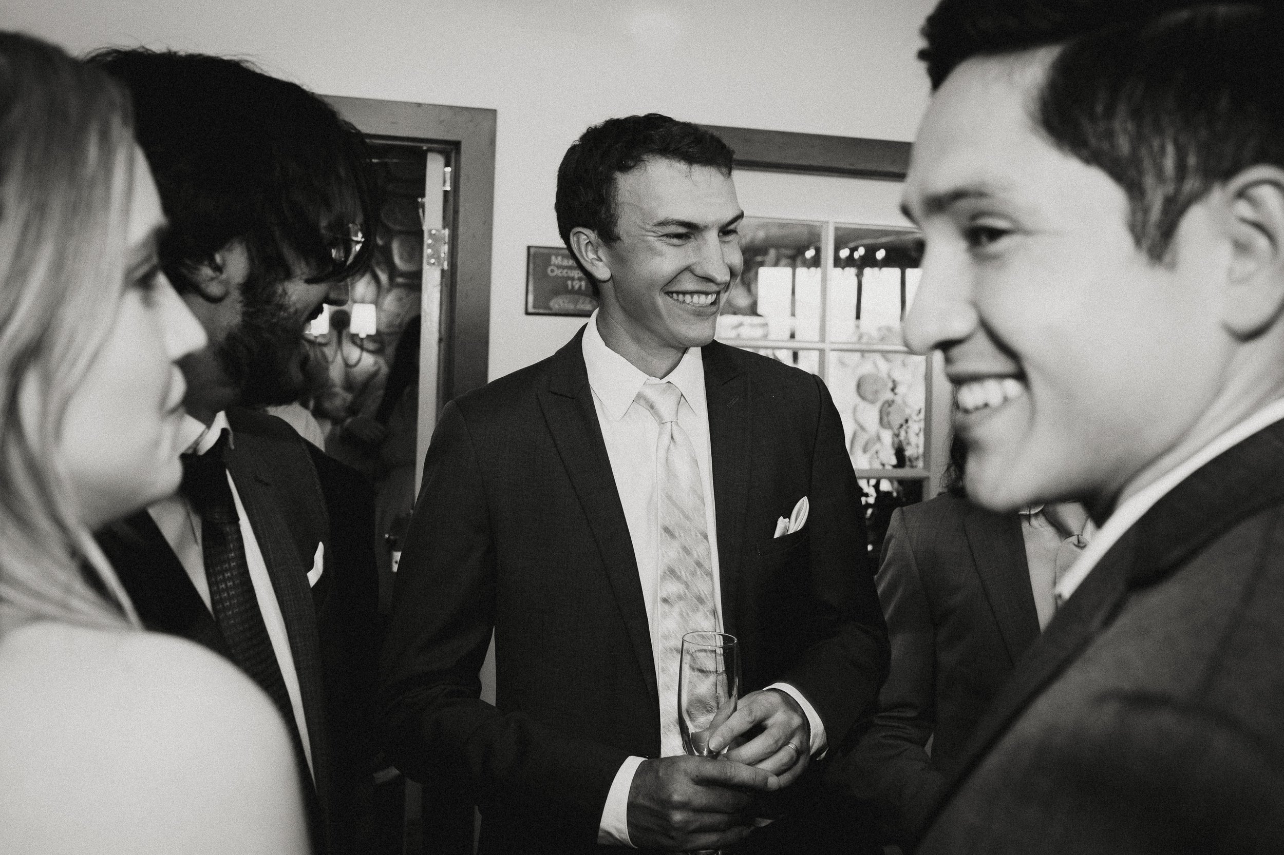 Groom with friends in black and white