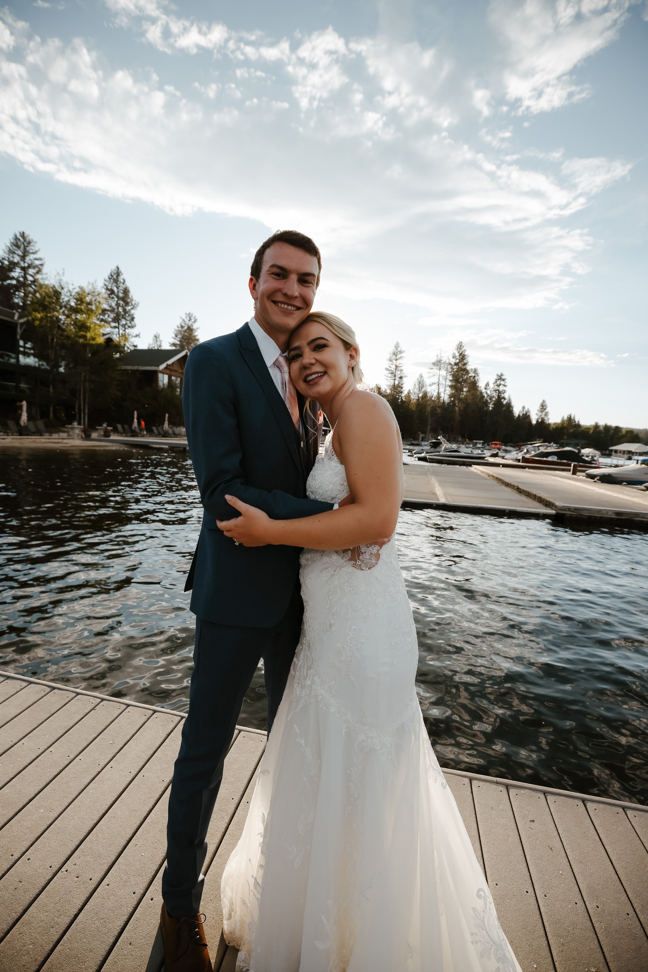 Bride and groom at golden hour lakeside