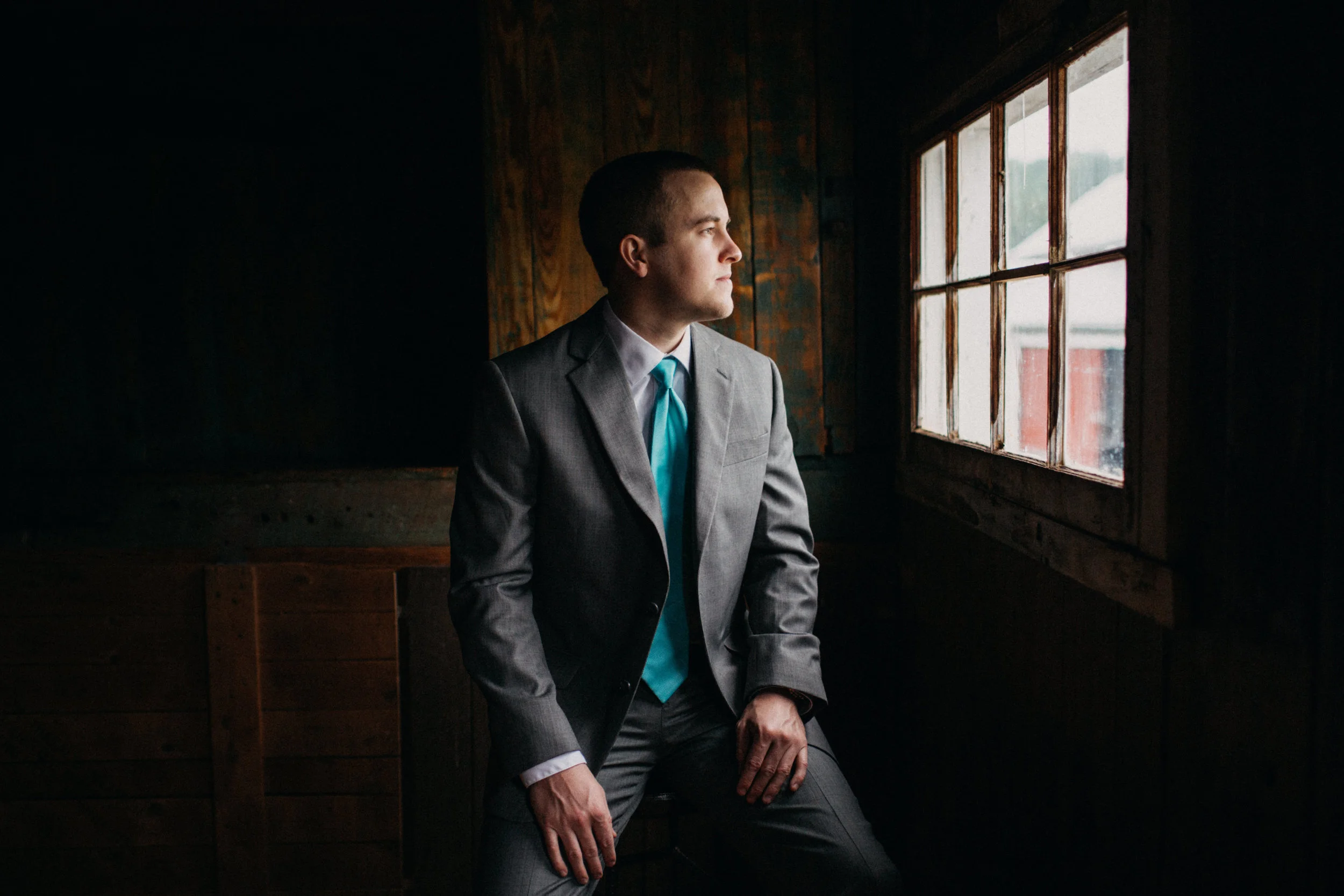 Portrait of groom sitting by window, at Rounton Farm.