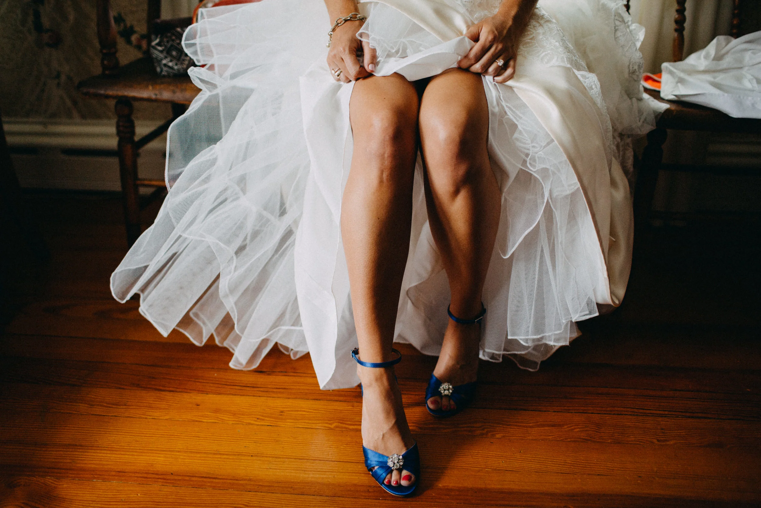 Photo of bride in wedding shoes.