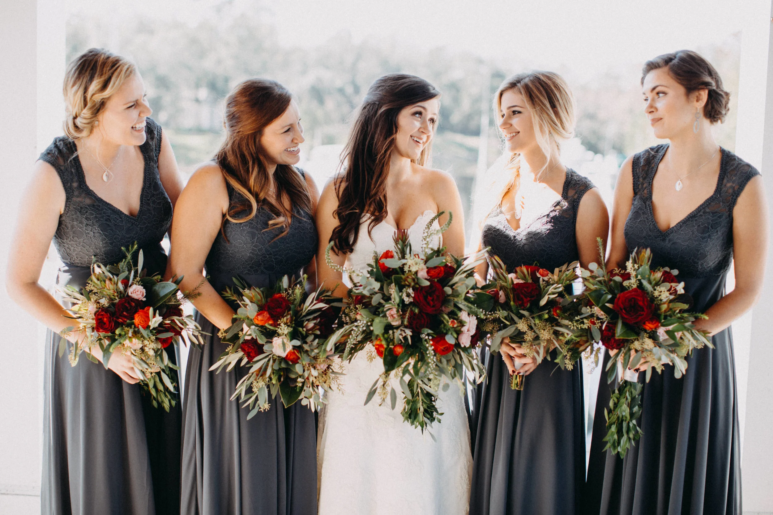 Photo of bride with bridesmaids outdoors.
