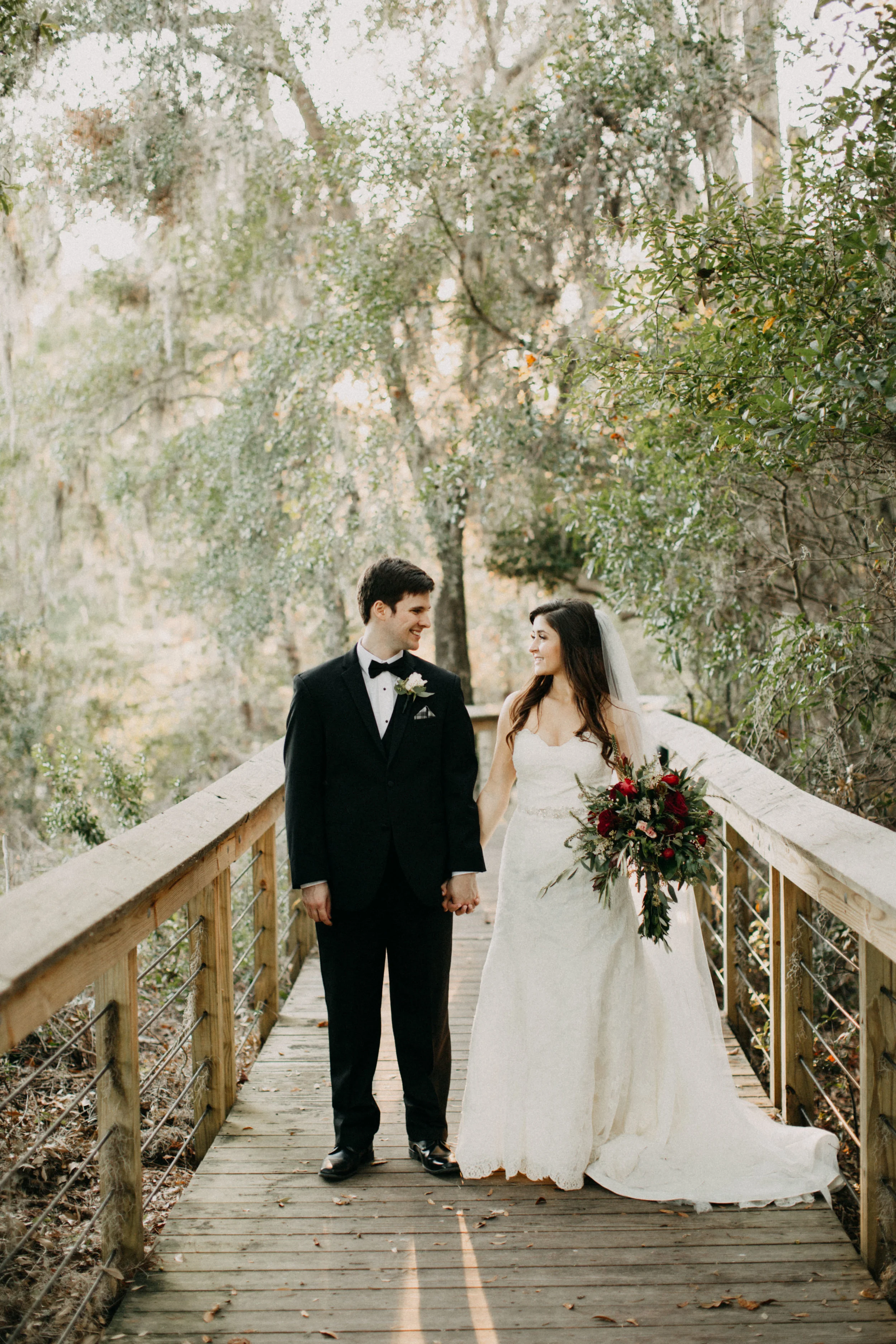 Portrait of couple standing together on bridge.