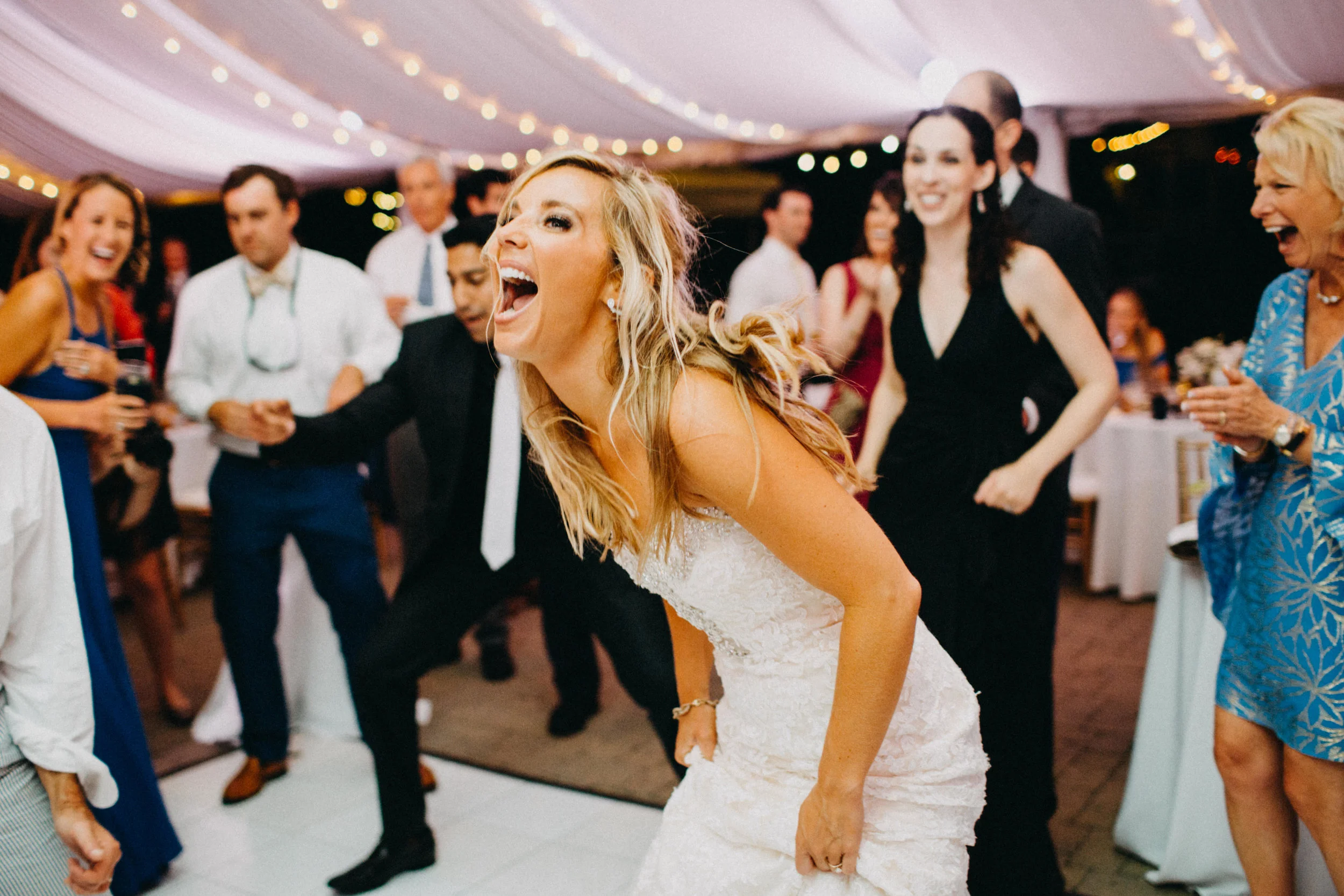 Photo of bride dancing at wedding reception.