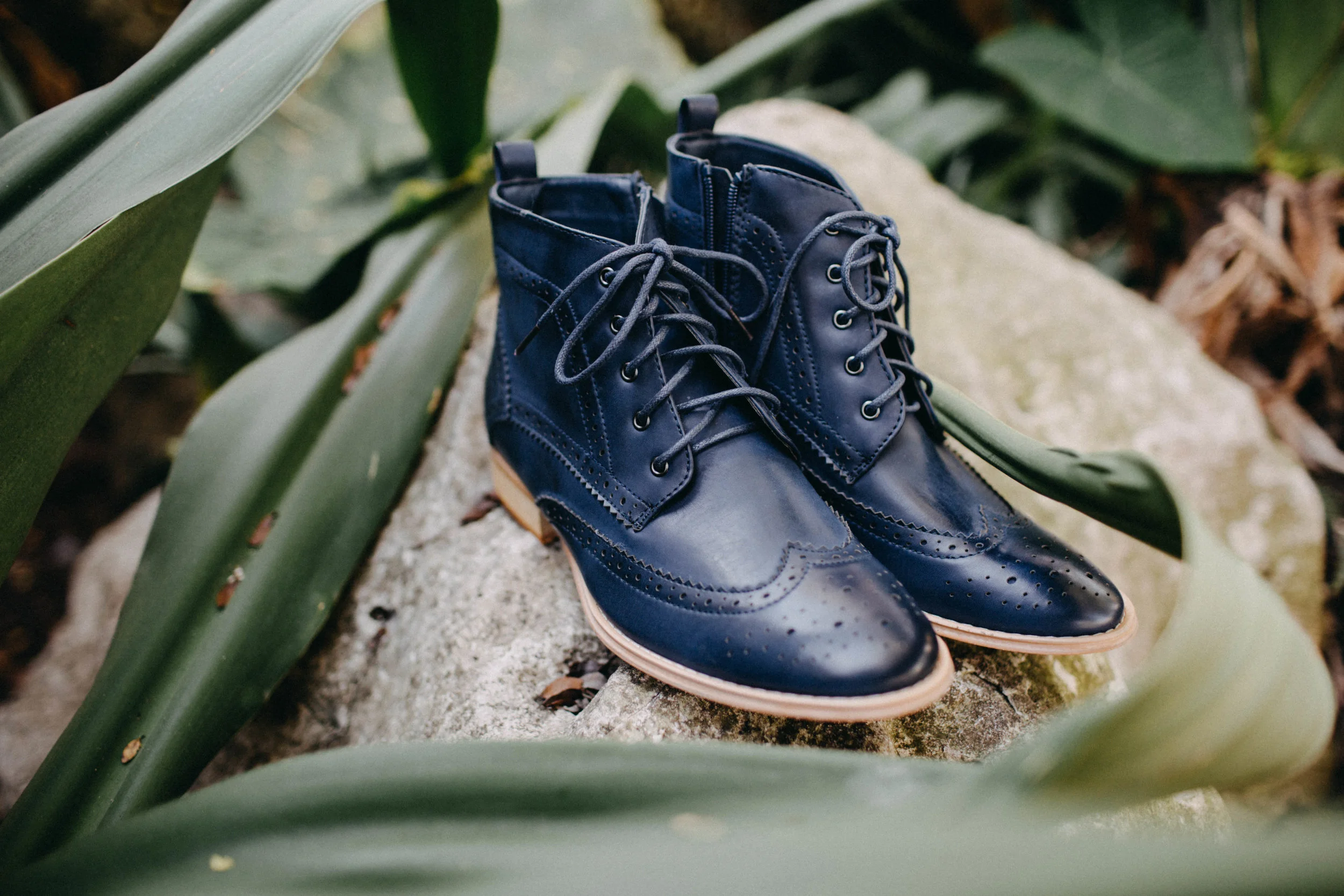 Photo of bride's wedding shoes on rock.