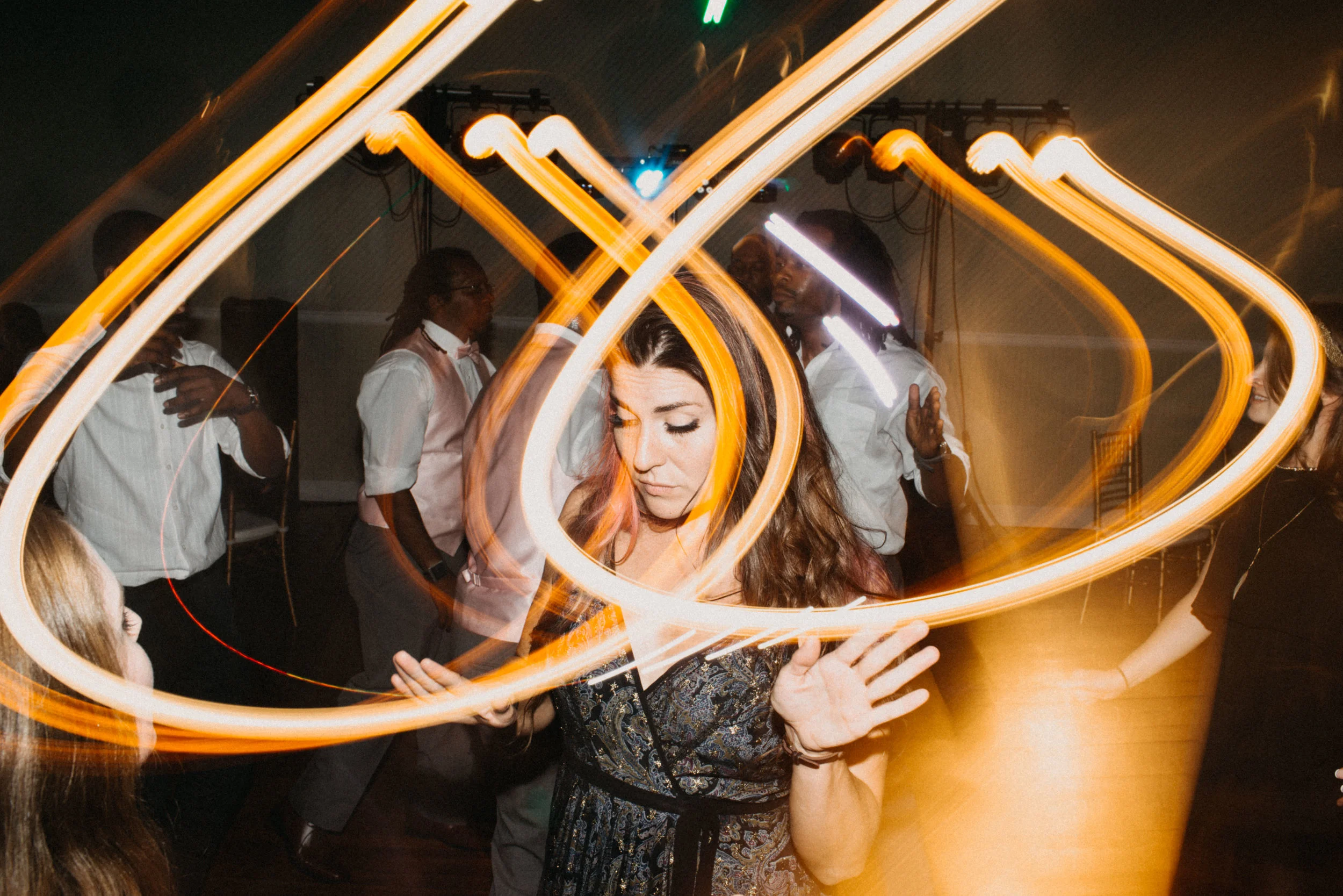 Photo of wedding guest dancing at reception.