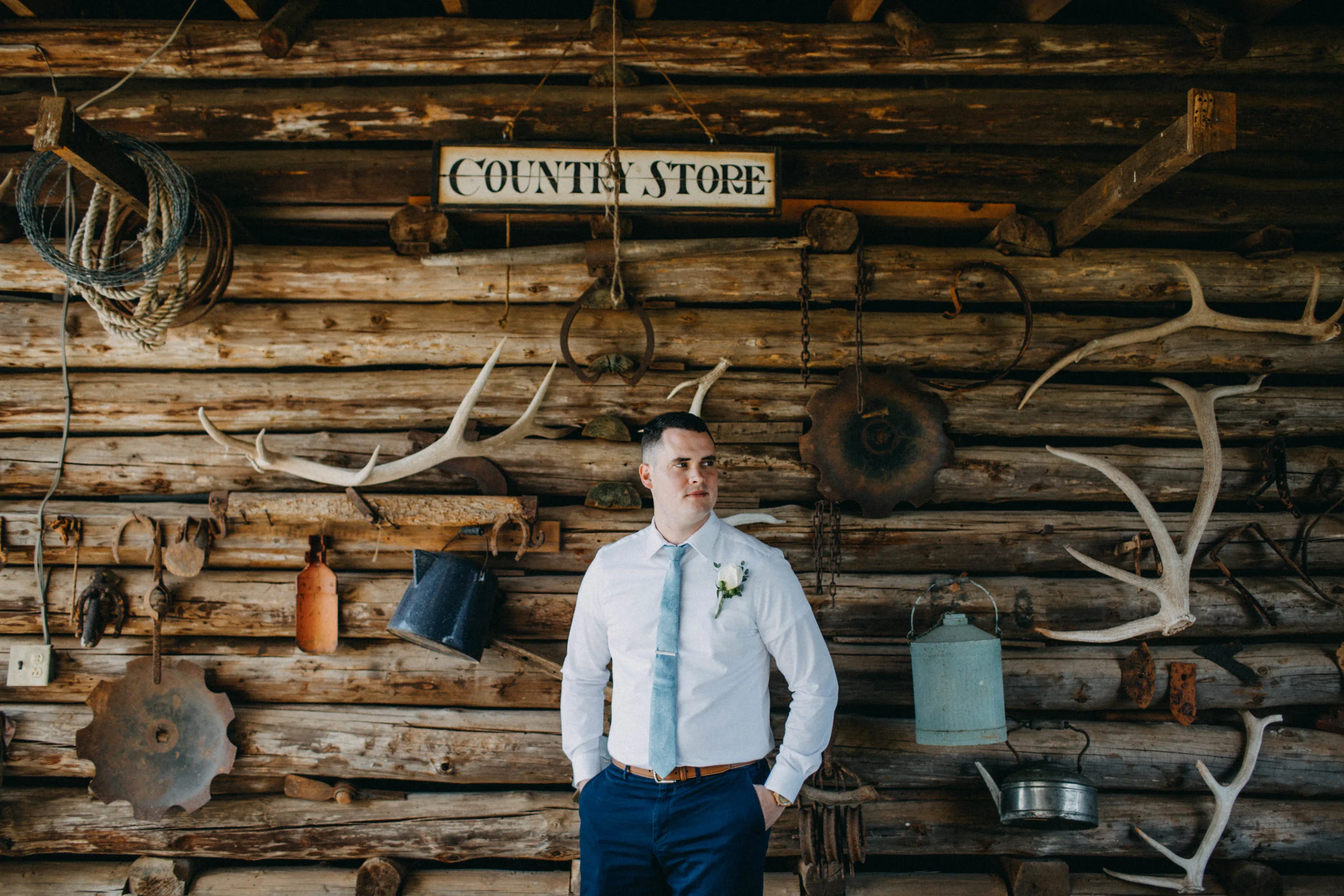 Portrait of groom standing by wall.