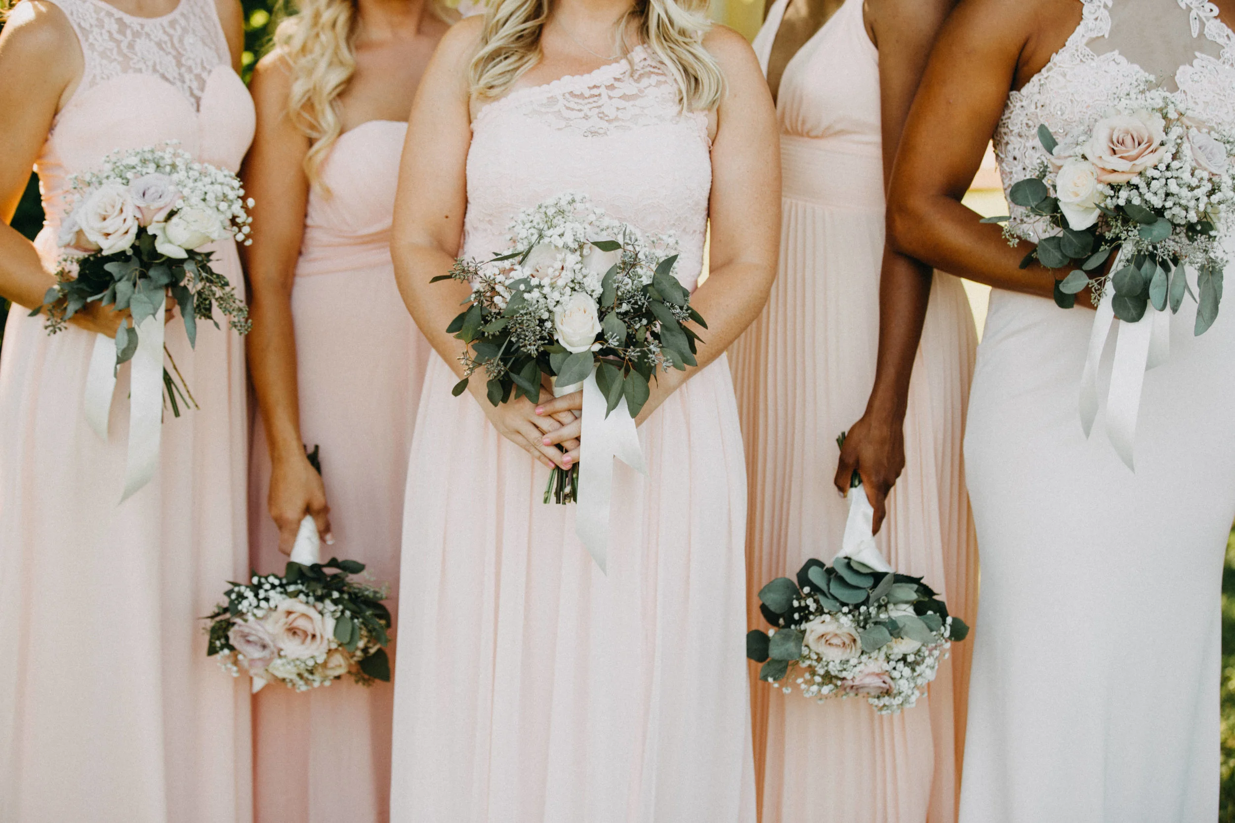 Bridesmaids holding bouquets.