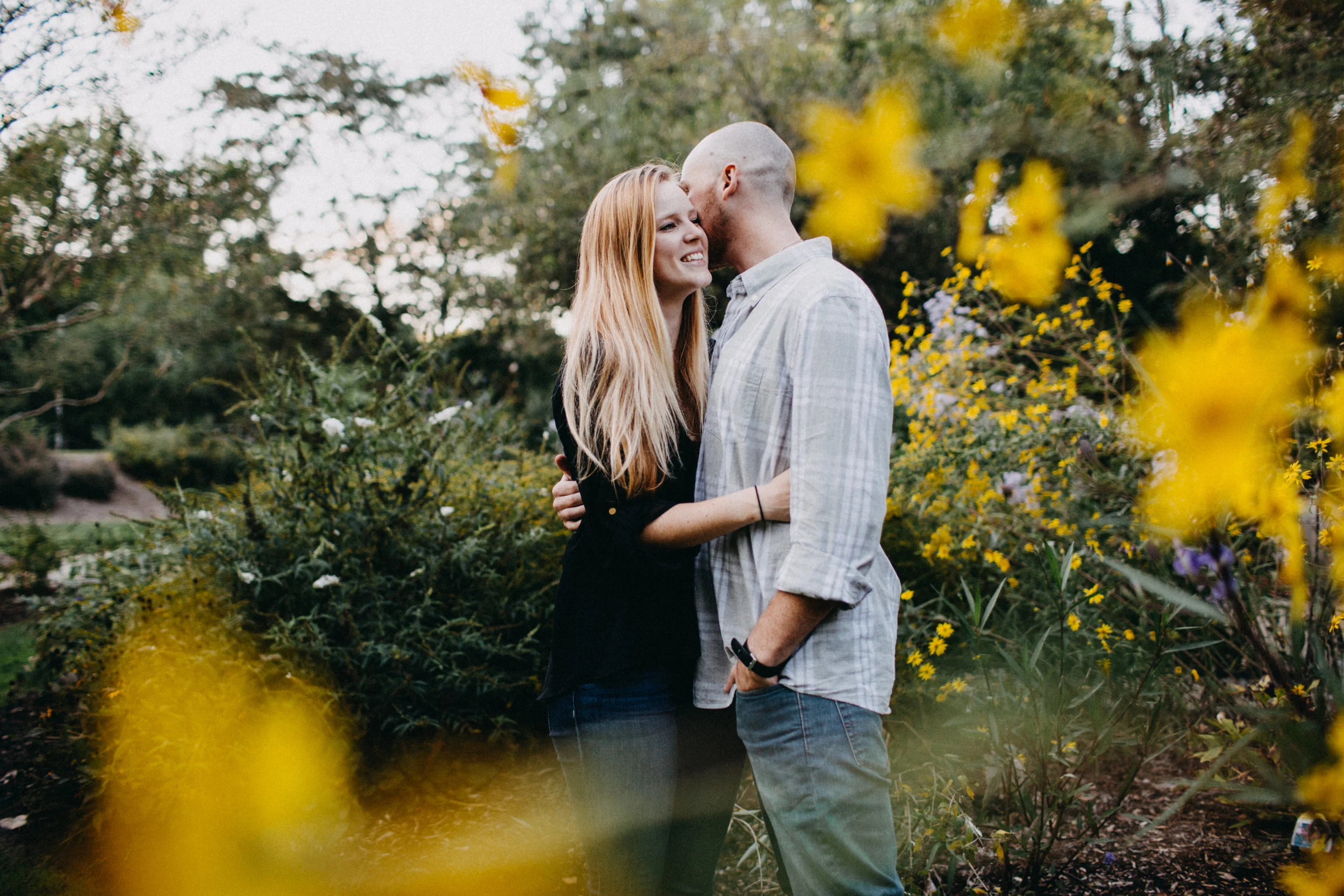 Couple embracing among flowers.