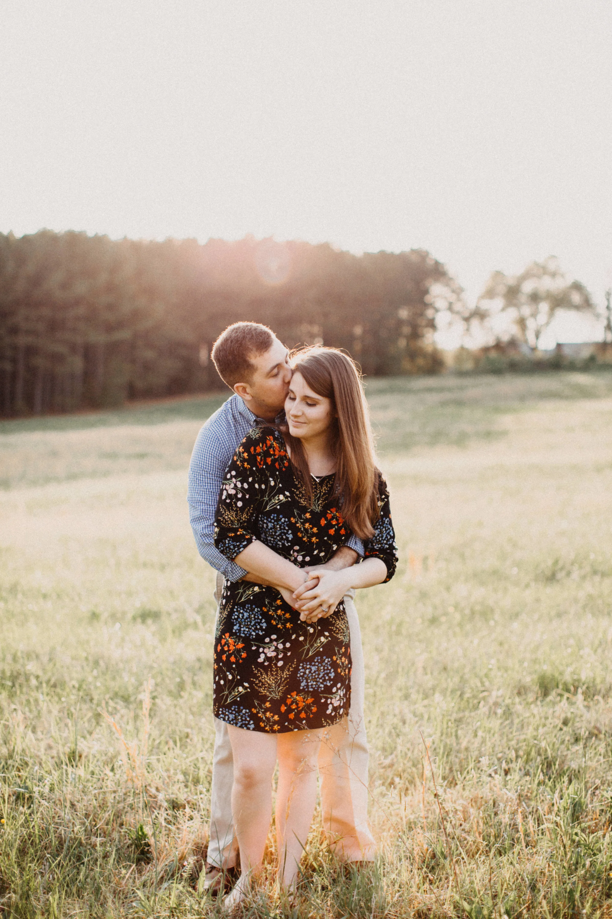 Couple standing in field.