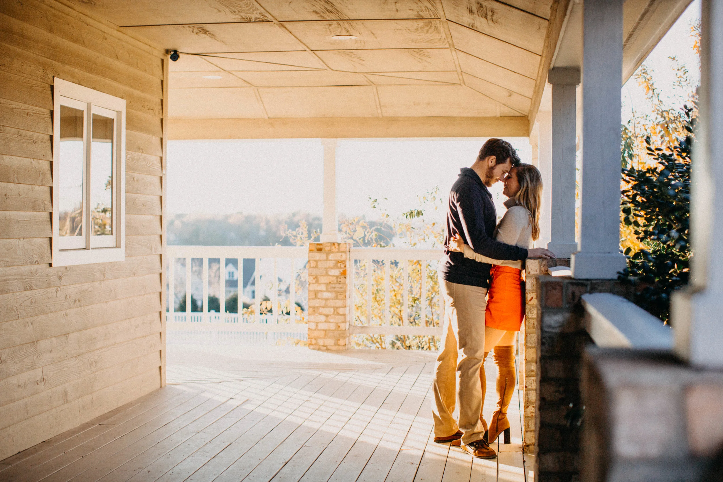 Couple embracing on porch.