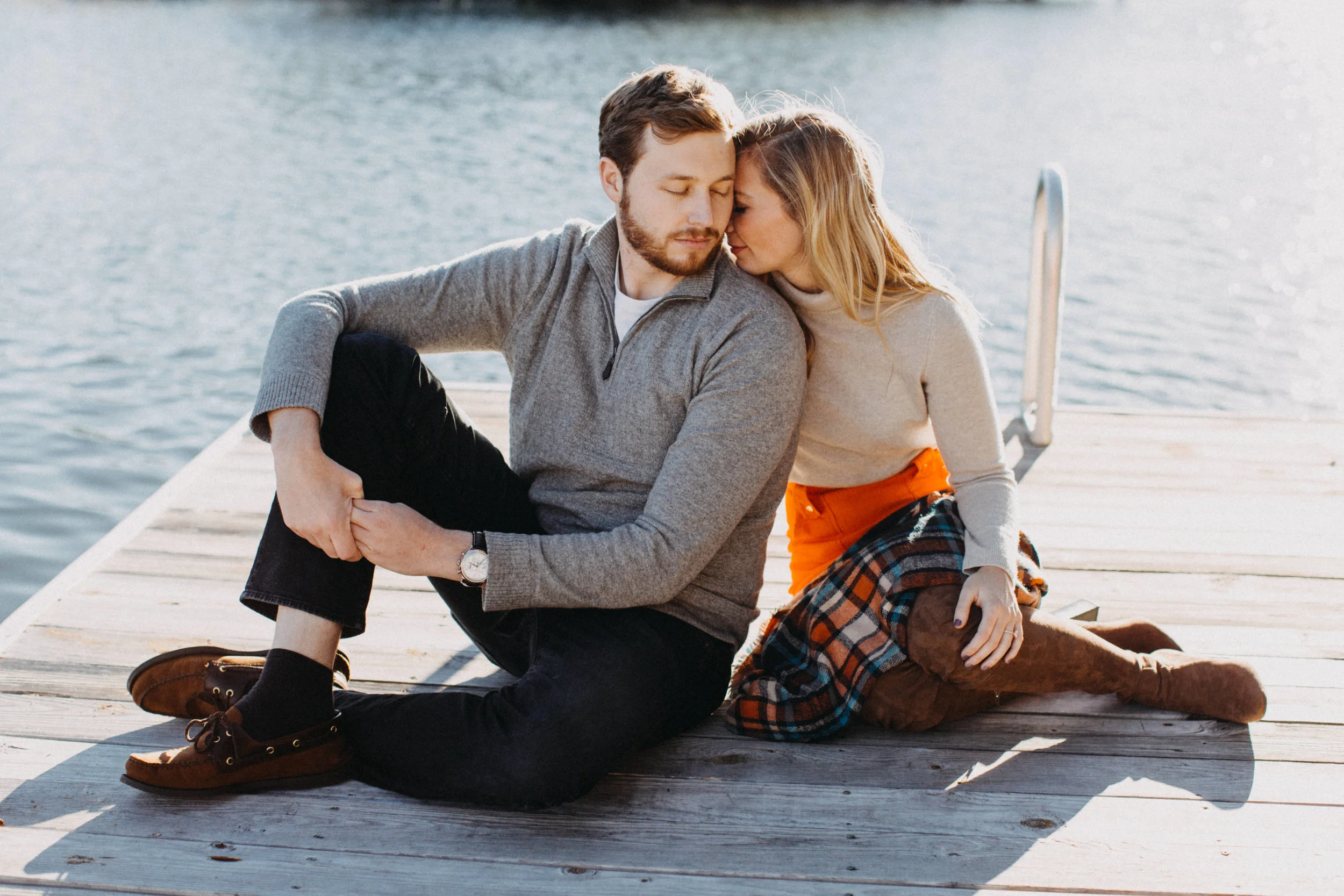 Couple sitting on dock at Smith Mountain Lake, in VA.