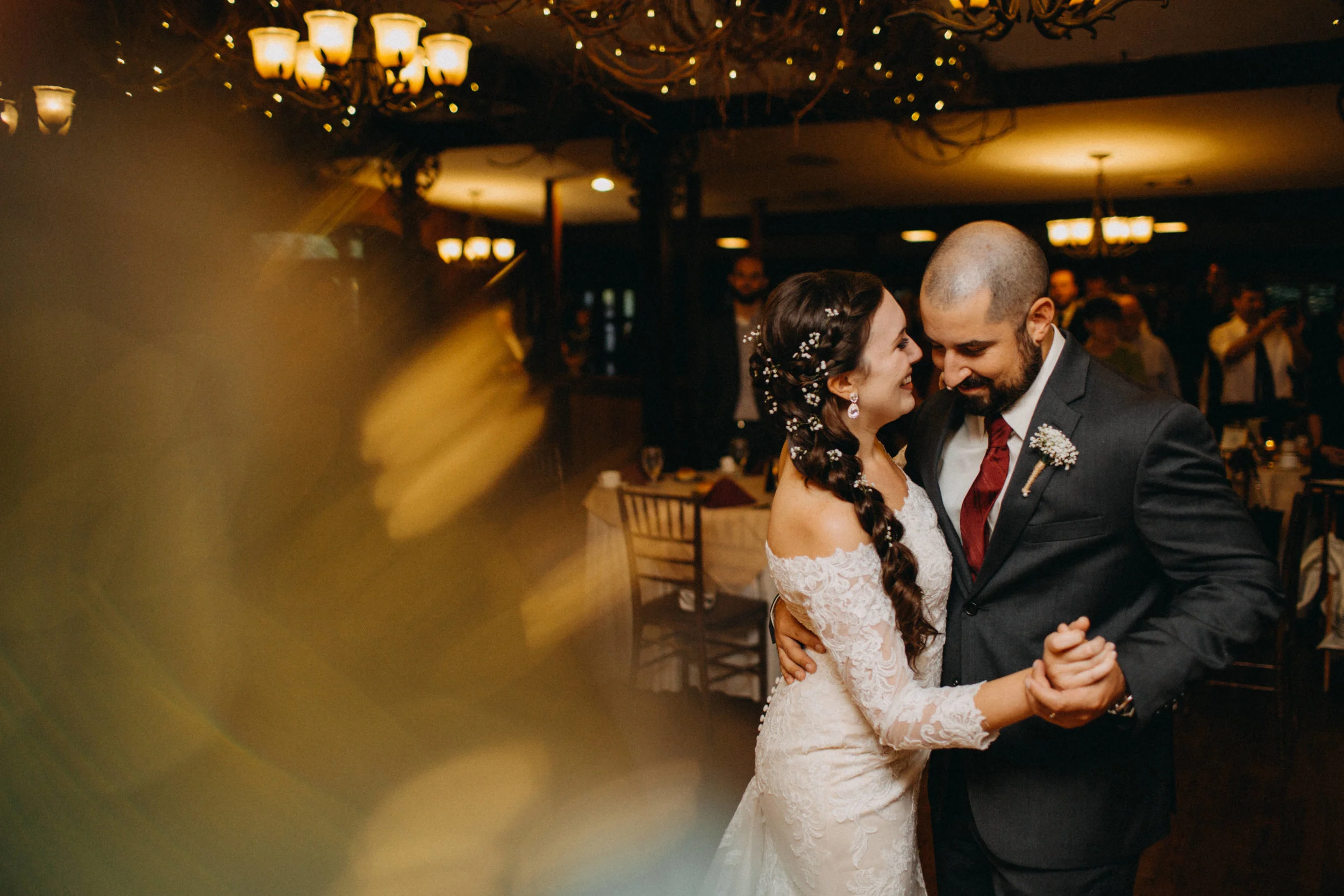Photo of bride and groom dancing at wedding reception.