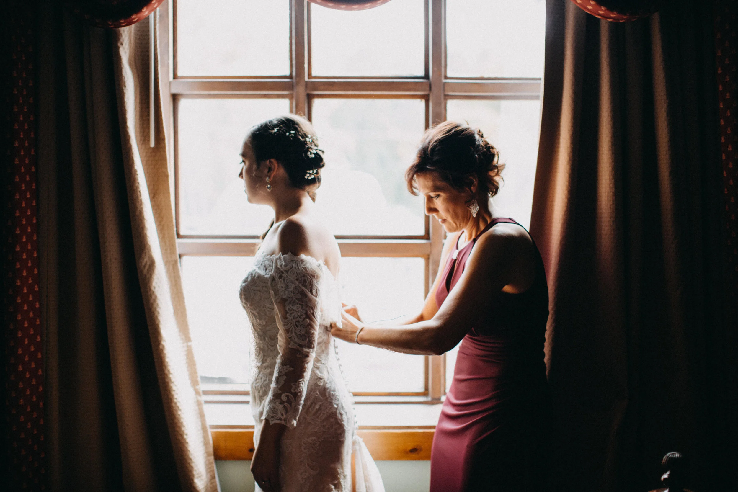 Bride and her mother getting ready for wedding.