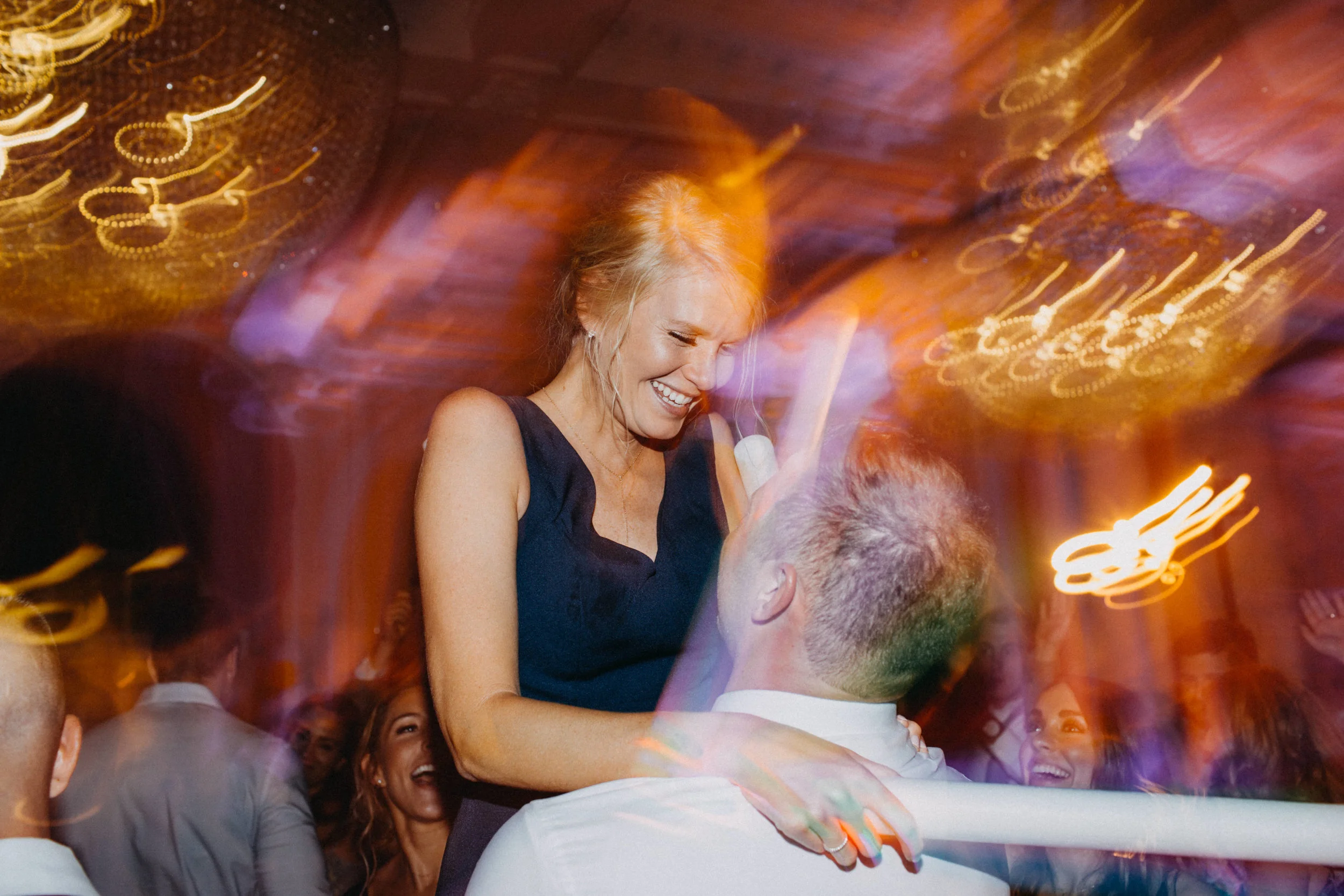 Wedding guests dancing at reception.