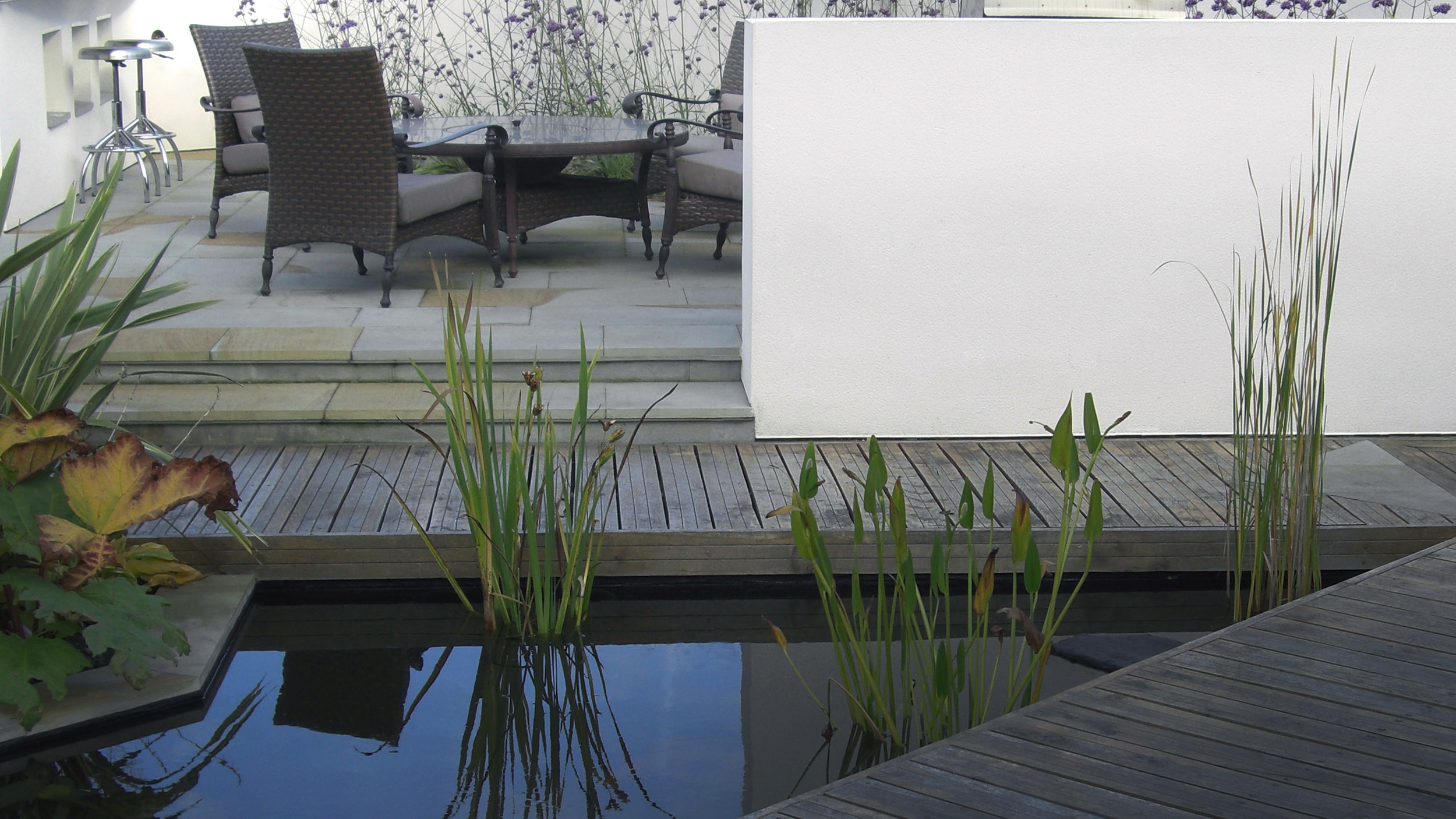 Contemporary garden designed with a water rill and dining area