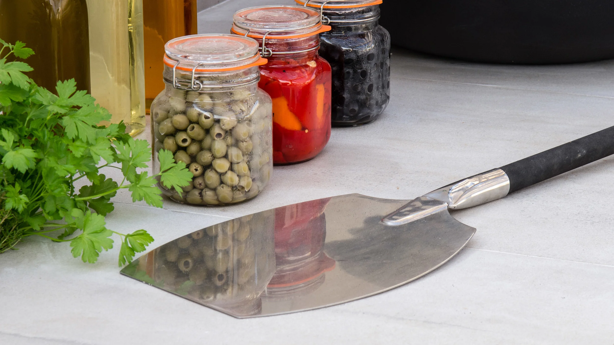 Southport Garden Design: A View Of The Olive Tree: Pizza Paddle, Herbs, Olives on an Outdoor Kitchen Workspace