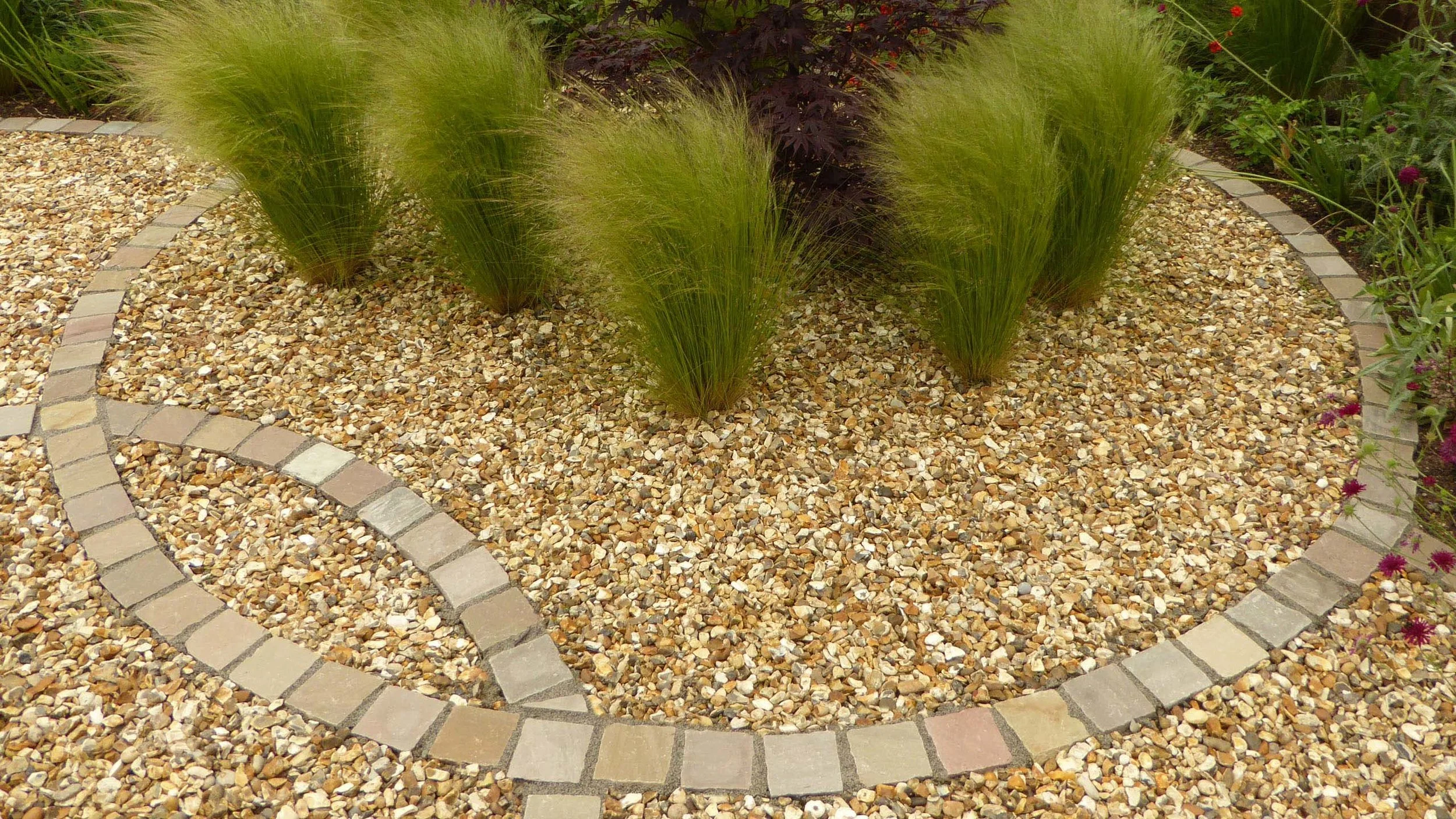 Cheshire Garden Design: Interlocking Curves and Acer (Front Garden) Grasses and gravel in a cobble circle