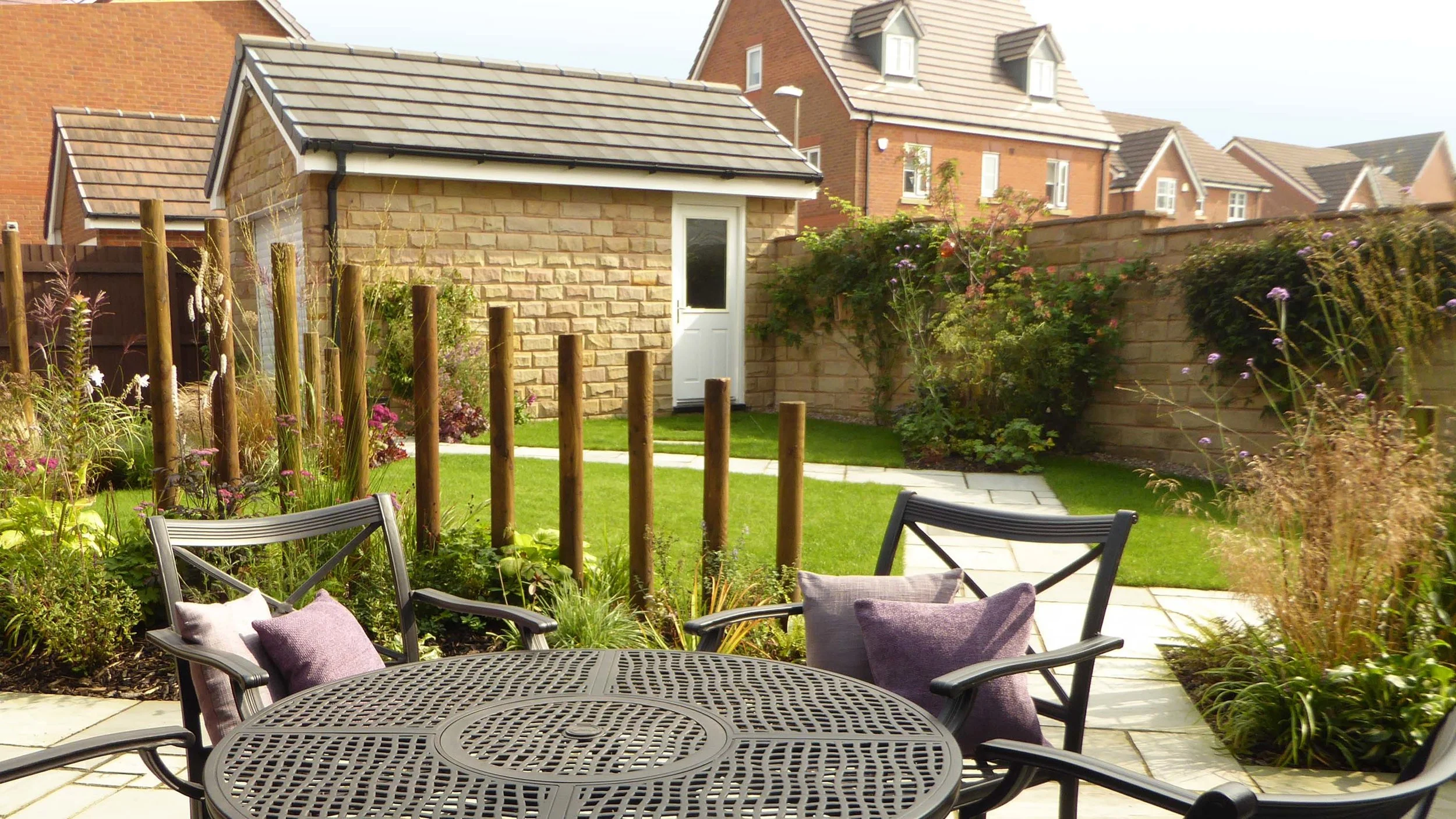 AFTER - New pathway allows better access, re-located tree into planting border and planting beds added with all year round interest.