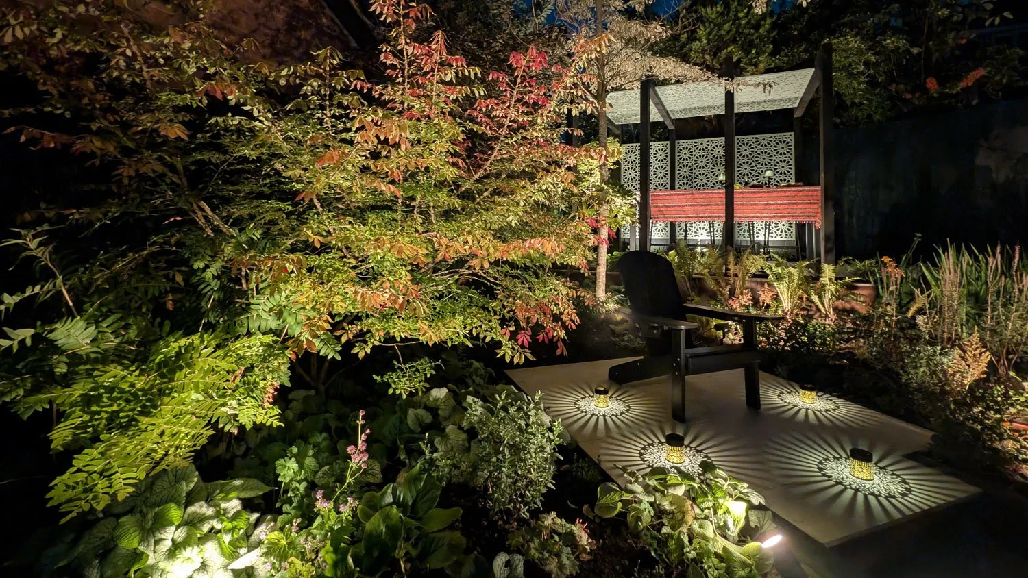 Secluded Garden Seating Illuminated at Night