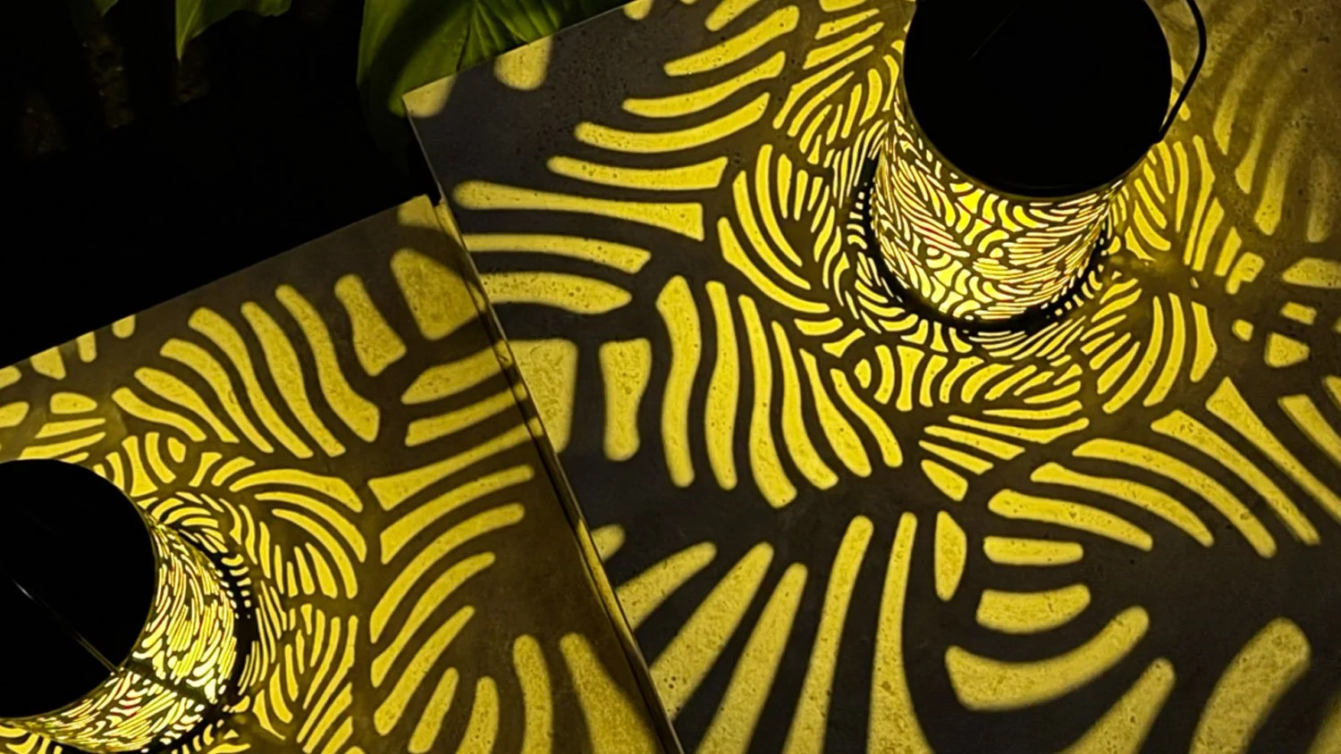 Patterned Lantern Light Projected Across Garden Paving
