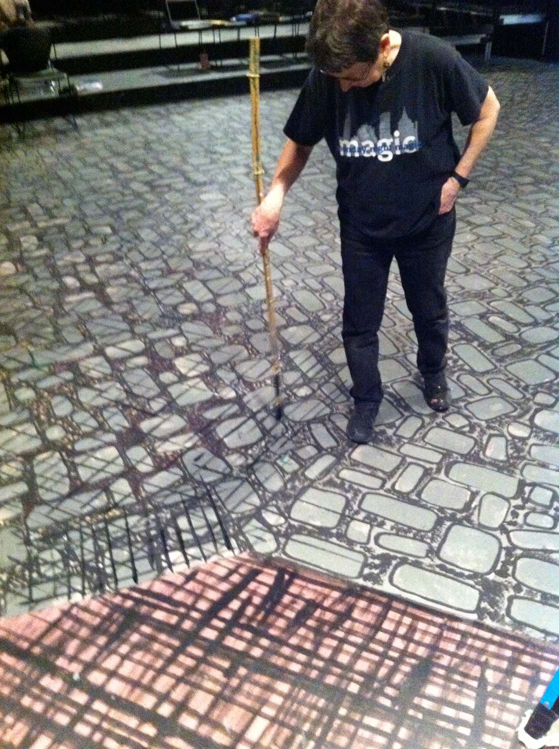 Scenic painting the stage floor for a production of Sweeney Todd: The Demon Barber of Fleet Street