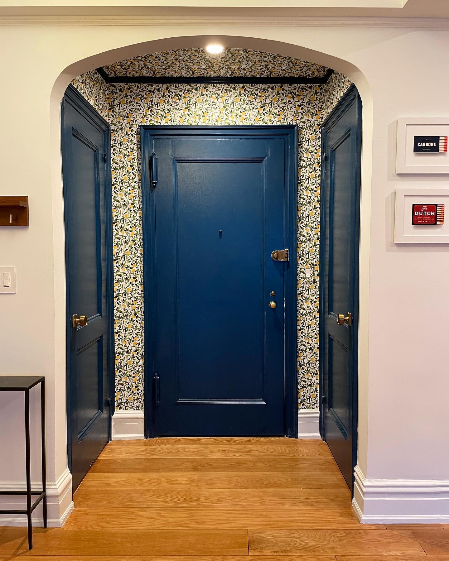 In today&rsquo;s edition of before and after: The entryway! We removed that dumb half-wall (you&rsquo;d be horrified at the number of columns that were in here), painted the doors and trim a deep blue, papered the walls and ceiling, and added a can l