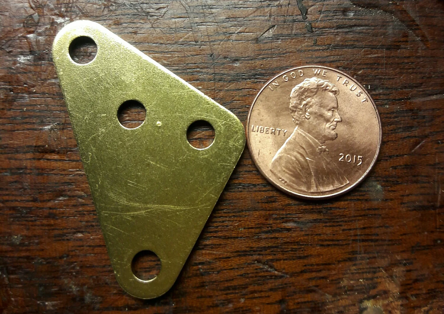 Sometimes you have to mark a part to make putting a clock back together easier . I've seen X' s and the word "out" scratched into parts . In this case I put a tiny dot in between the two top holes . I know the dot faces out and it also is the up direction when it gets put back in place . A nicer way to treat the movement without putting scratched in words or symbols like the X' s. 